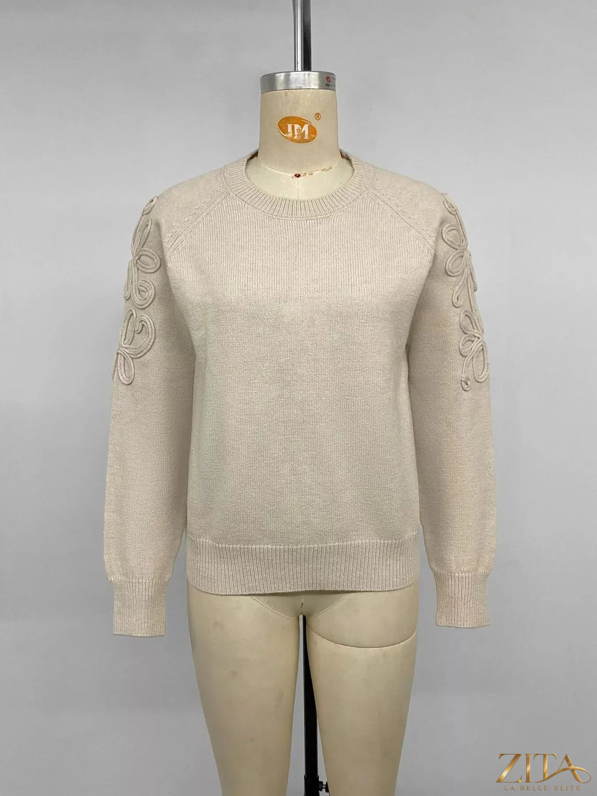 Floral raglan sleeve sweater by Trendsi featuring colorful floral pattern on soft knit fabric, long sleeves, and casual style.