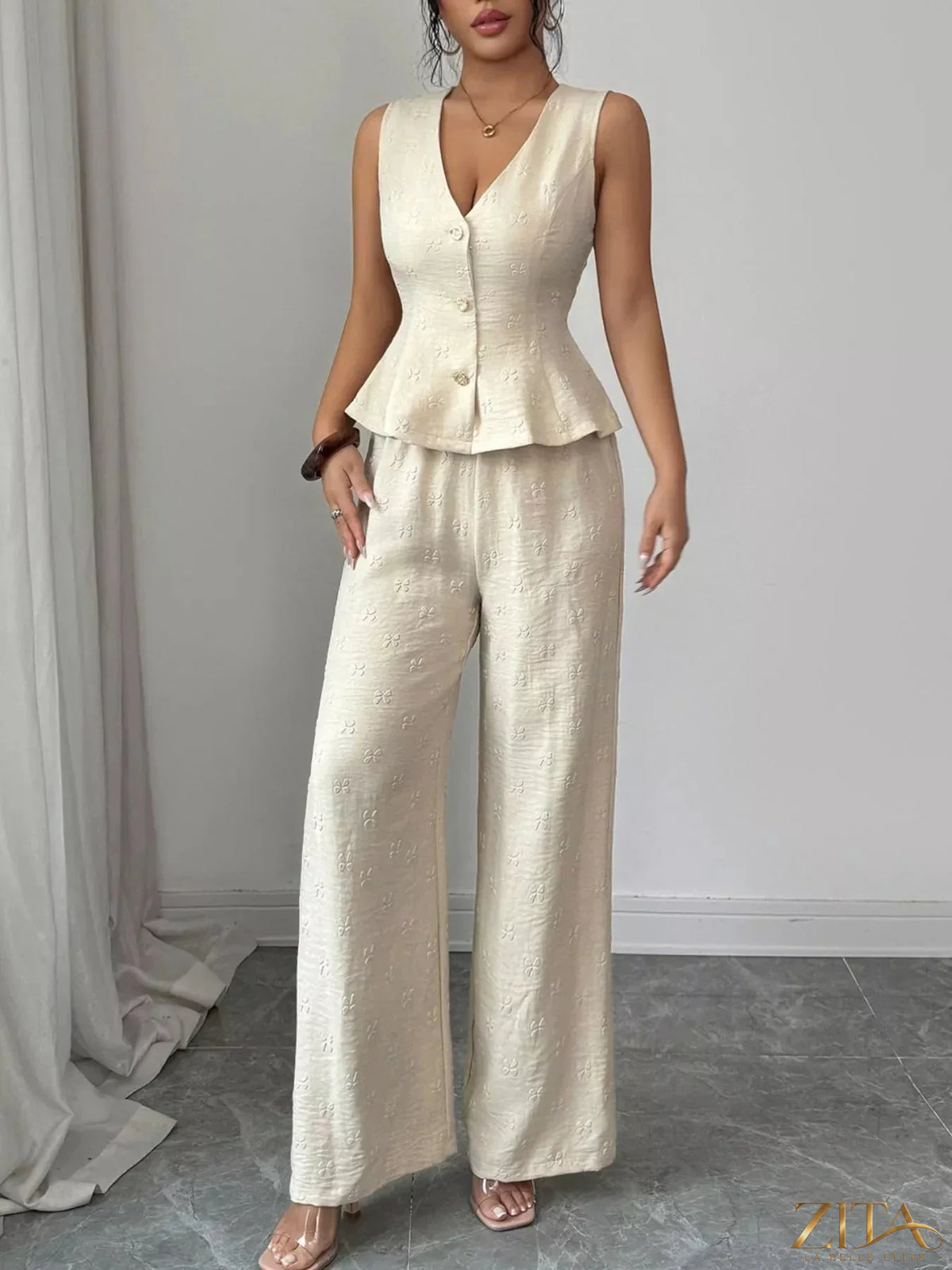 Zita La Belle Elite sleeveless peplum top and wide-leg pants set, black and stylish, shown on a model against a neutral background.
