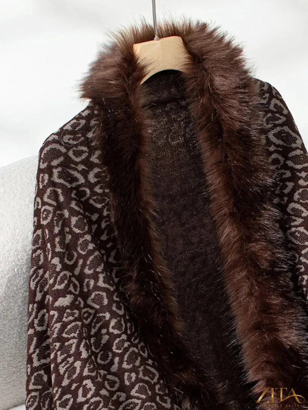 Leopard print fringe open front long sleeve poncho by Trendsi featuring a stylish design with fringed edges and a relaxed fit.