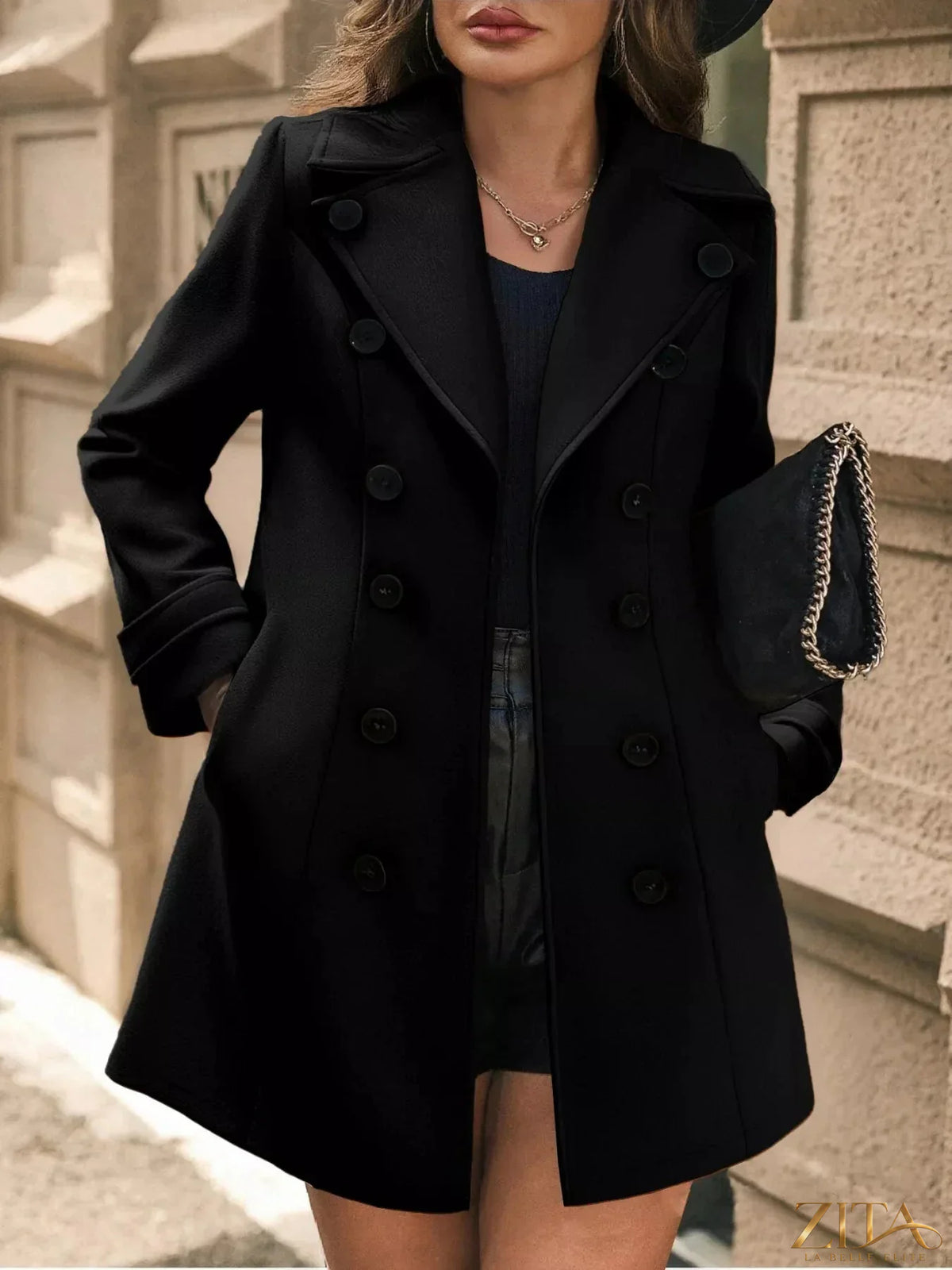 Zita La Belle Elite double-breasted wool blend overcoat hanging on a wooden hanger, tailored with wide lapels and button details.