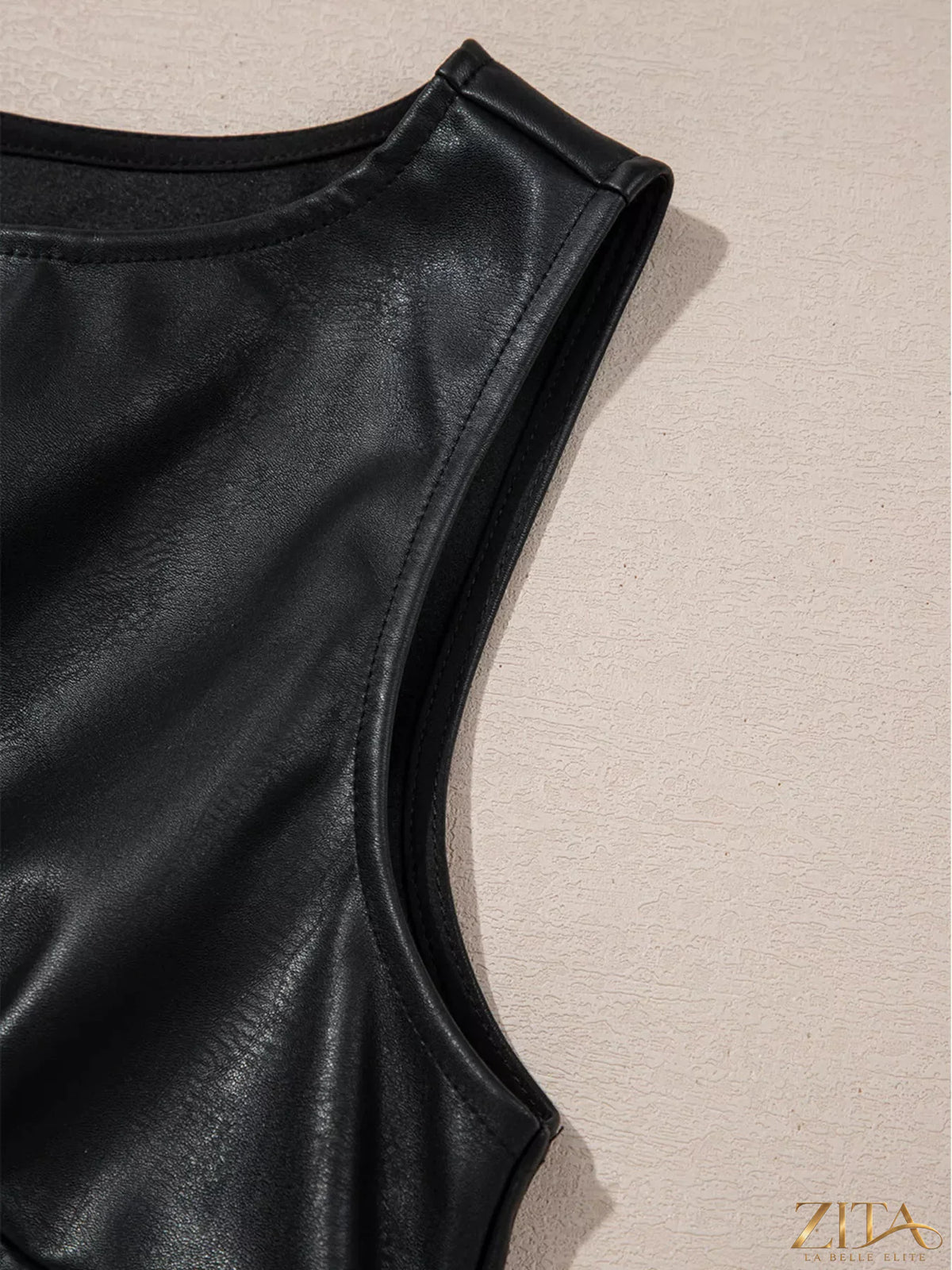 Vegan leather sleeveless mini dress by Zita La Belle Elite, shown in black with a fitted silhouette and stylish neckline.