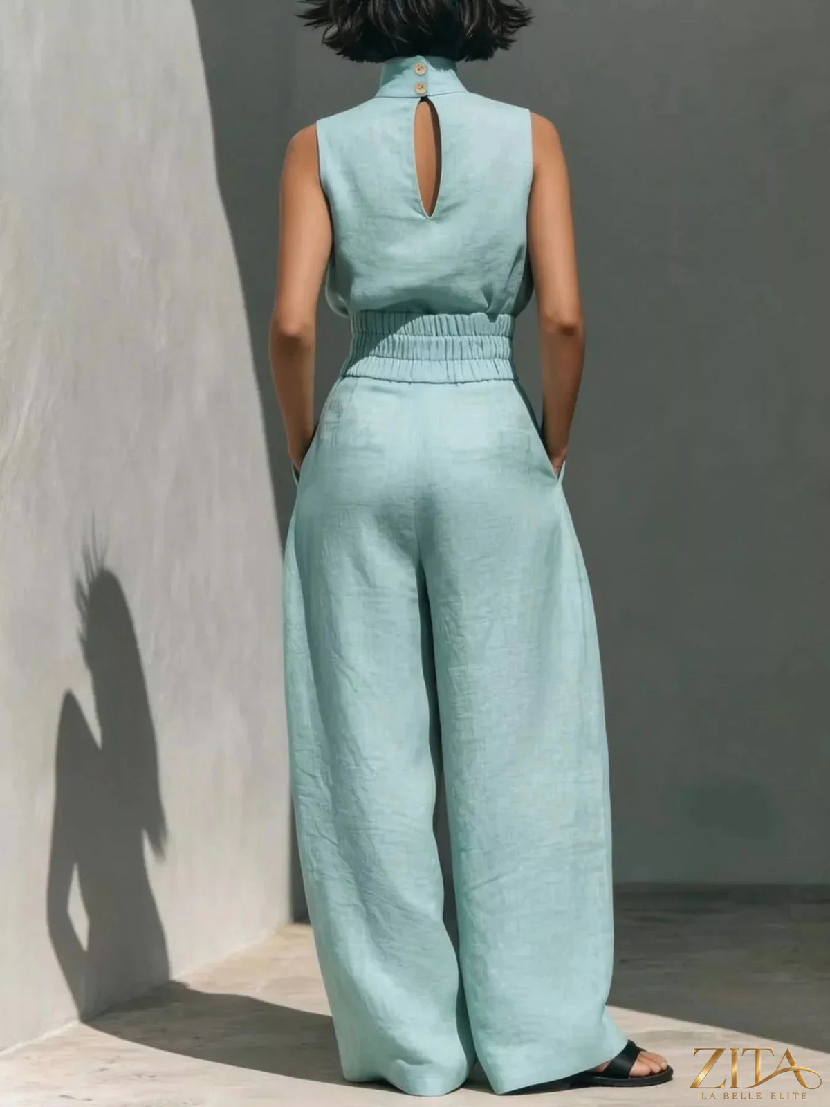 Sleeveless turtleneck top and wide-leg pants set by Trendsi, featuring a sleek, coordinated look in soft fabric.