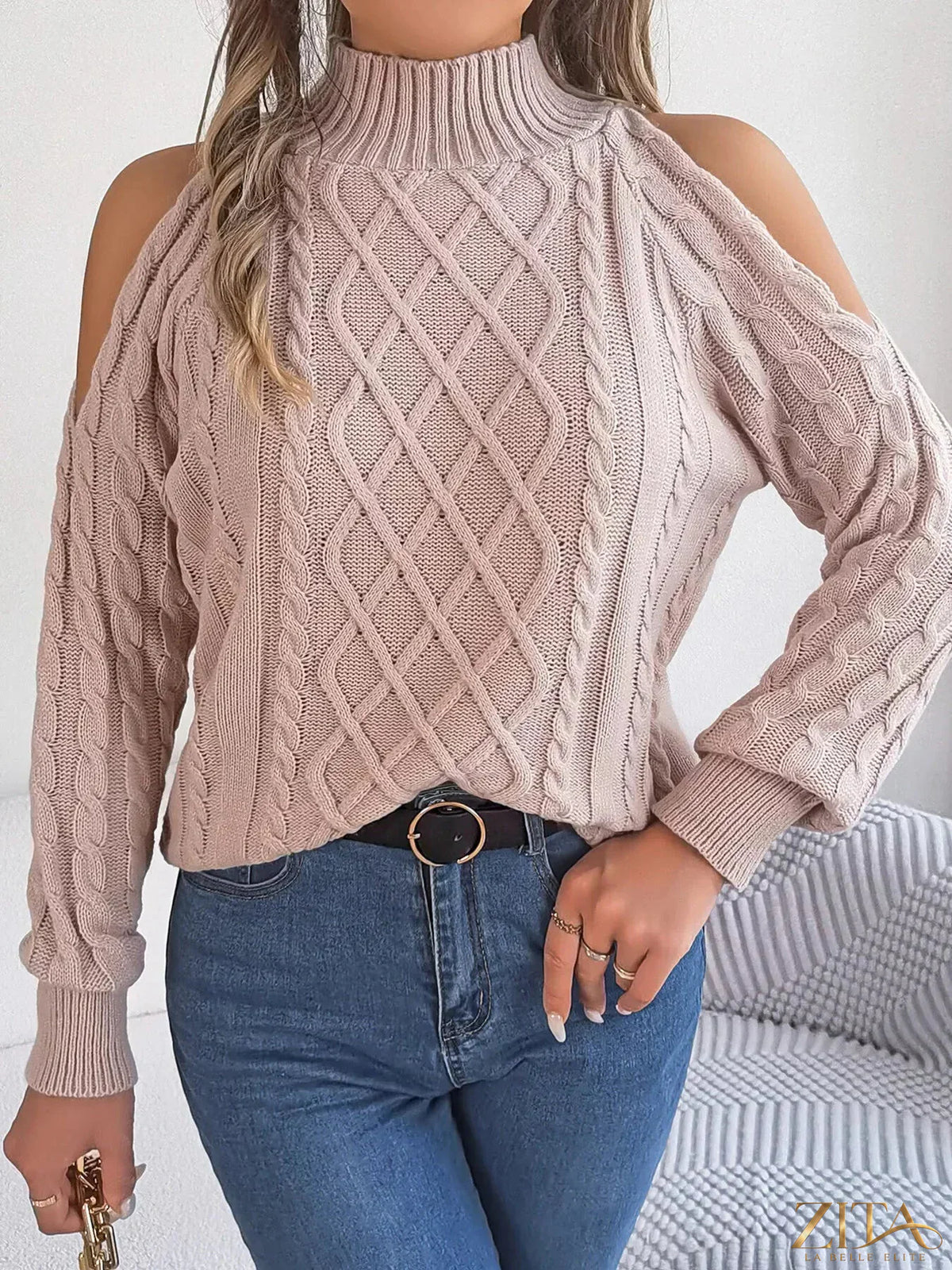 Zita La Belle Elite cold-shoulder cable knit sweater in cozy cream with open shoulder design and textured knit pattern.