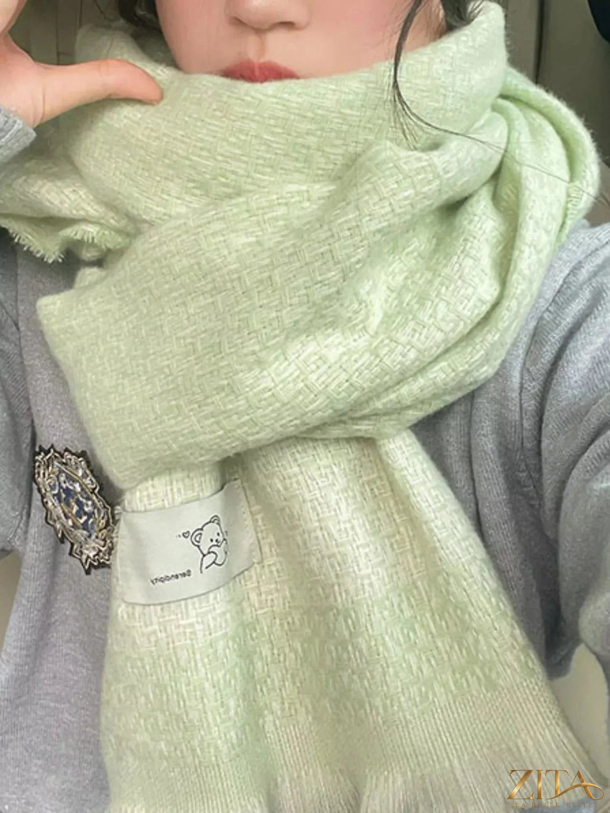 Raw hem scarf by Zita La Belle Elite featuring soft fabric and fringed edges, styled in neutral tones.