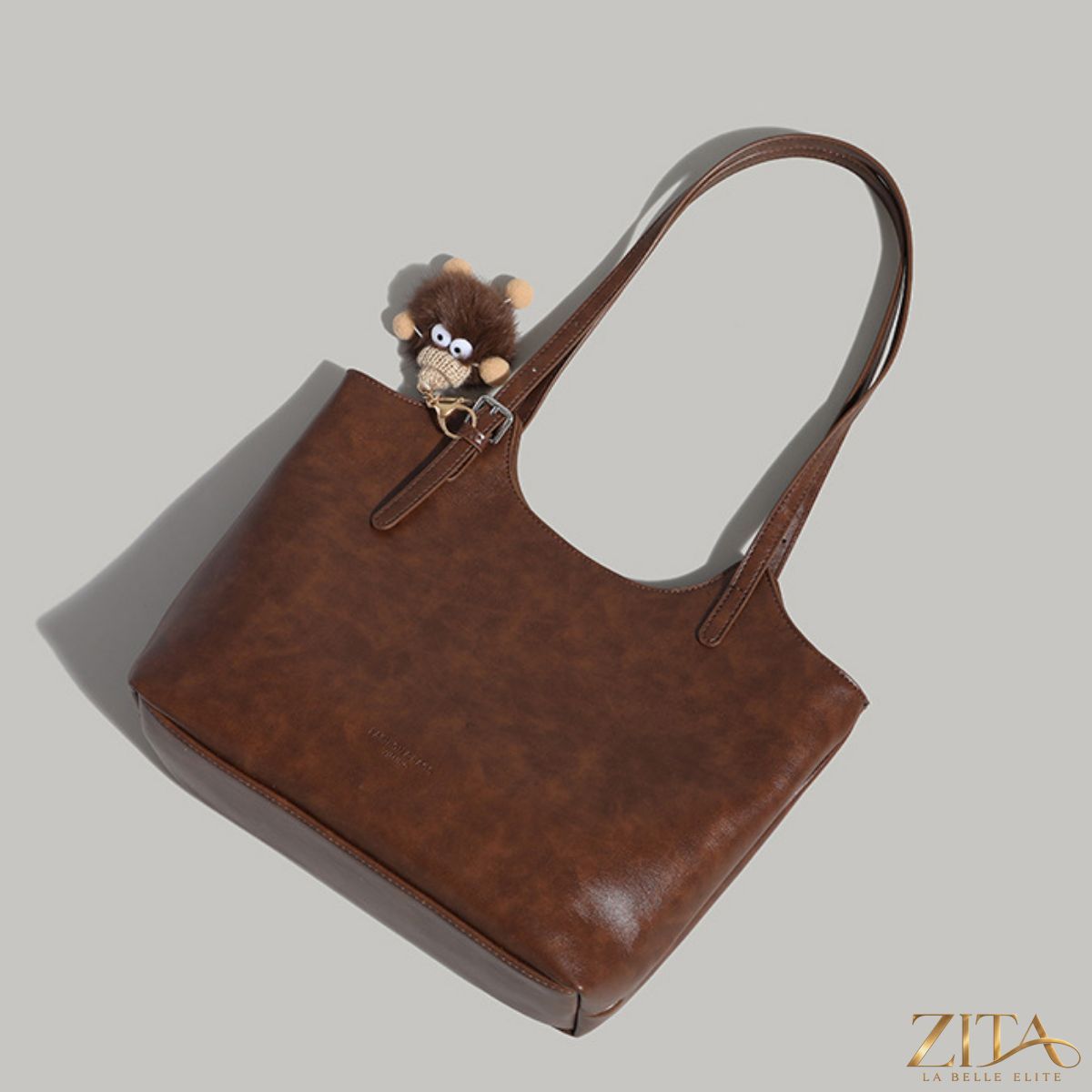 Zita La Belle Elite leather tote bag with decorative charm, featuring spacious interior and stylish design for everyday use.
