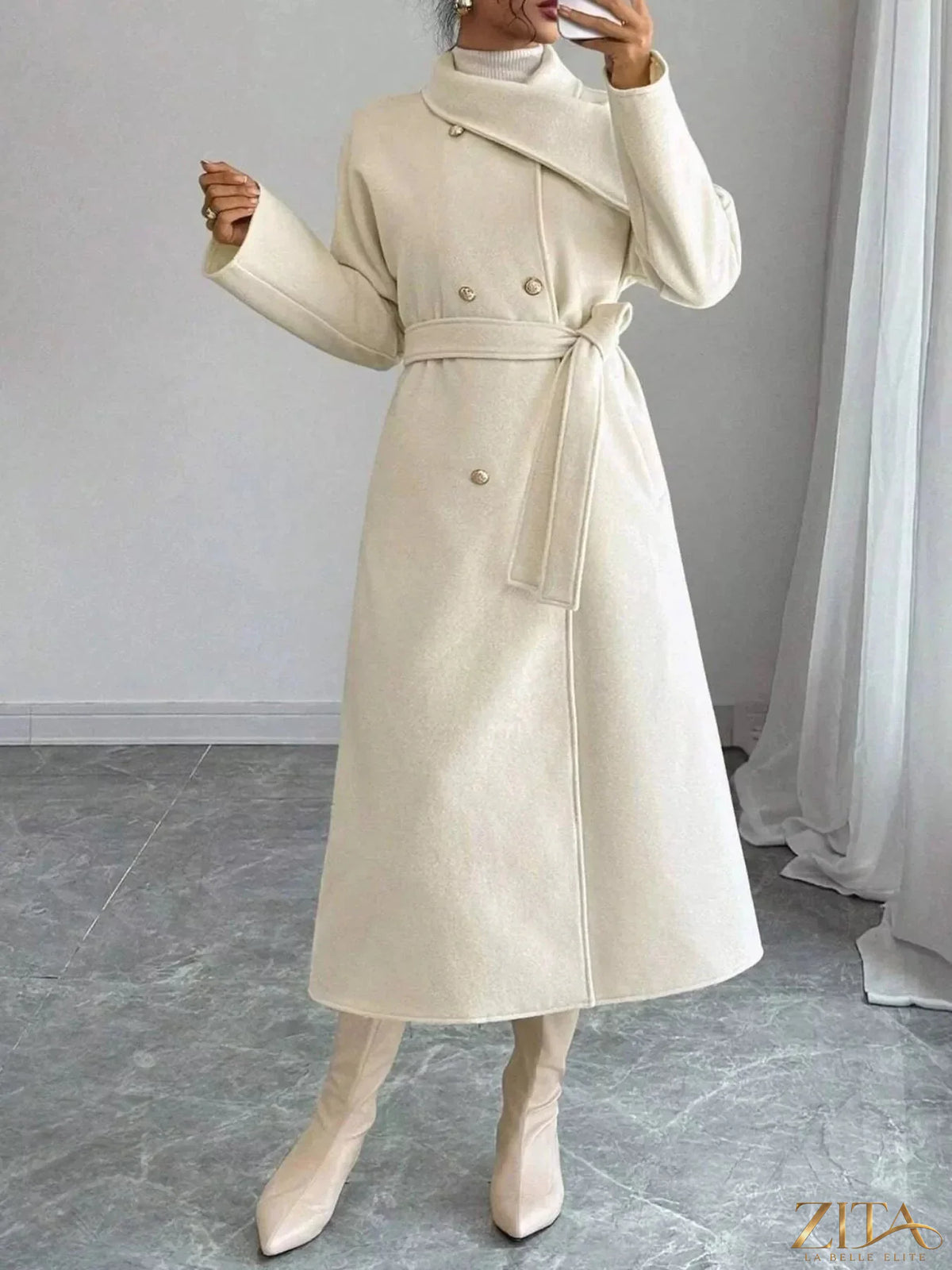 Zita La Belle Elite double-breasted longline coat in dark fabric, featuring wide lapels and a tailored silhouette.