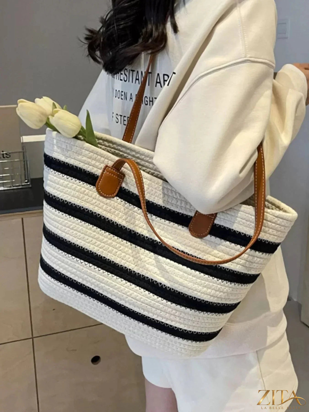 Striped straw tote bag by Zita La Belle Elite featuring woven design and sturdy handles for beach or casual use.