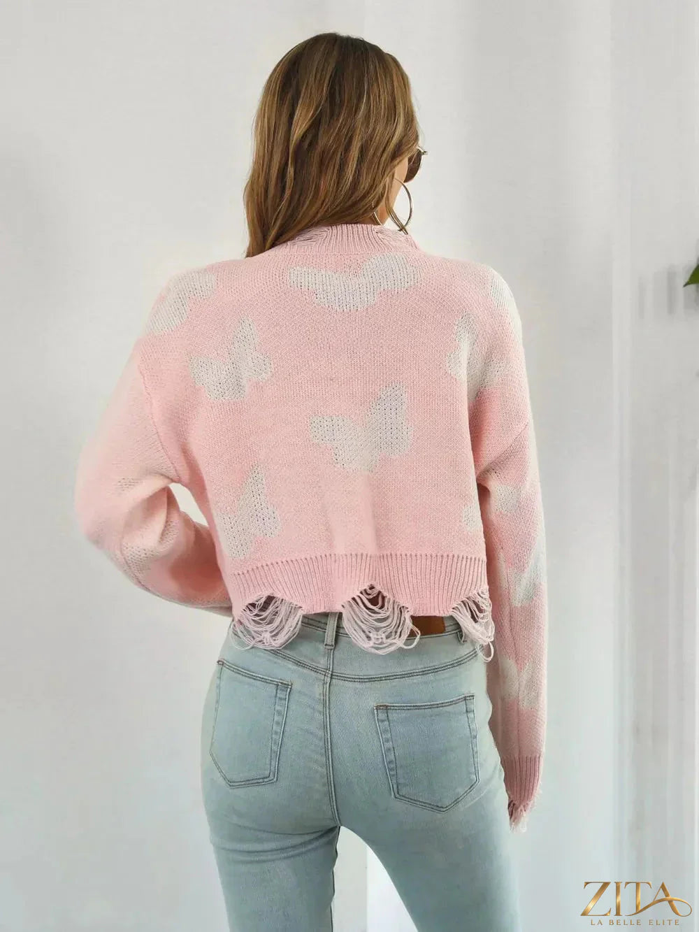 Distressed butterfly print cropped sweater by Zita La Belle Elite, featuring a trendy, casual design with a distressed finish.