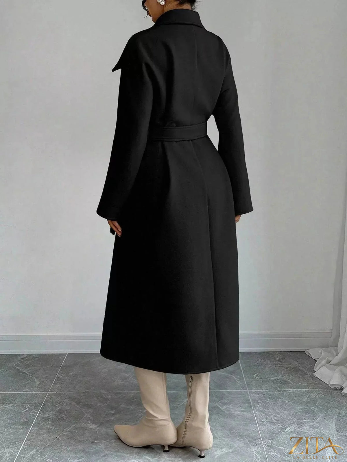 Zita La Belle Elite double-breasted longline coat in neutral fabric, displayed on a hanger against a white background.