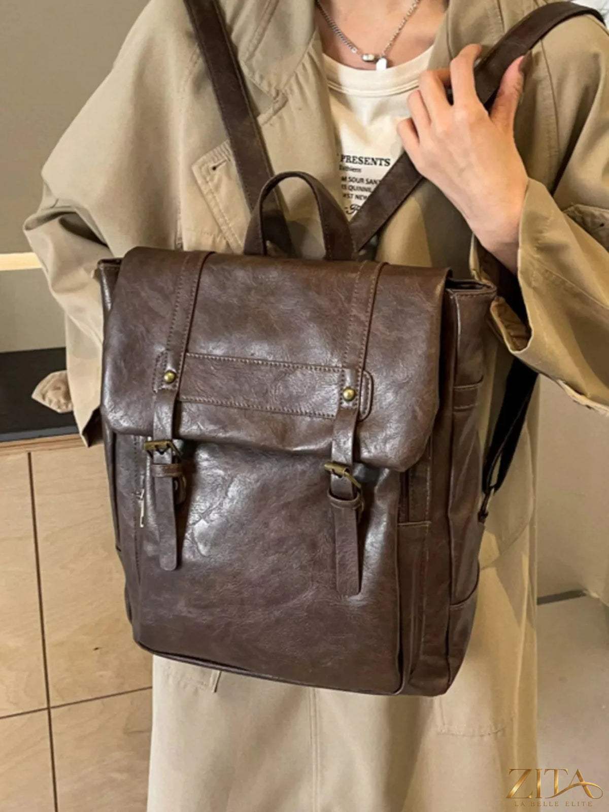 Leather flap backpack bag by Trendsi featuring a stylish brown leather design with adjustable straps and front flap closure.