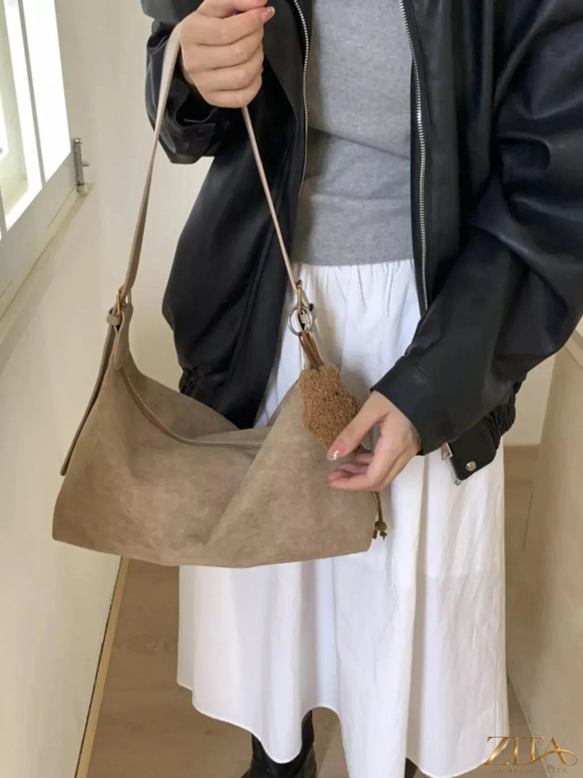 Zita La Belle Elite solid color suede hobo crossbody bag with a relaxed, curved design and adjustable strap.