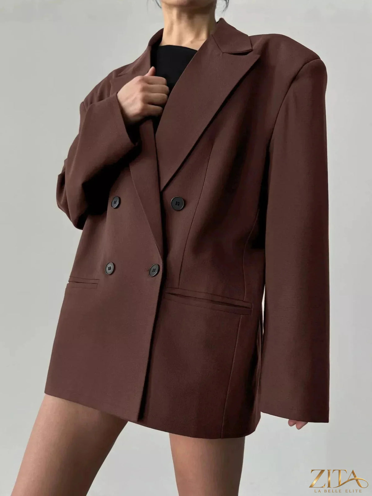 Black double-breasted blazer with lapel collar from Trendsi, featuring tailored fit and stylish design for professional or casual wear.