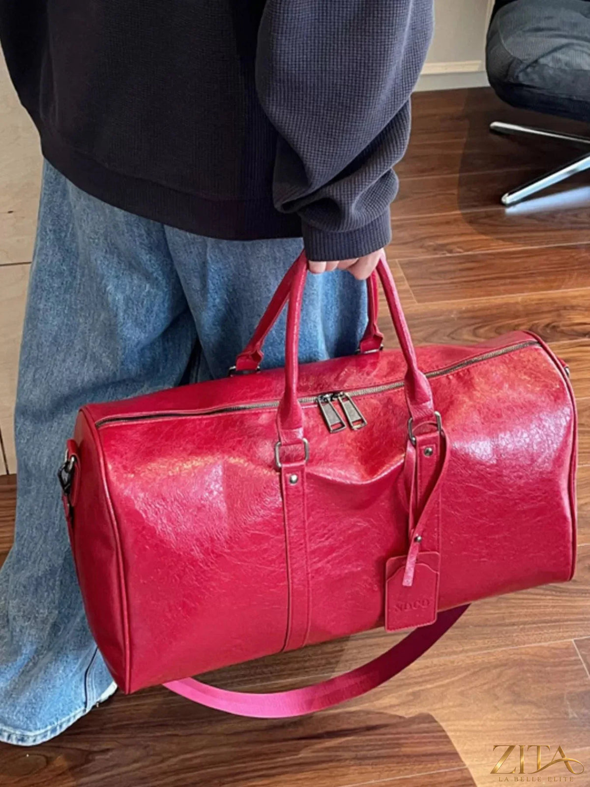 Trendsi PU leather duffle bag with sturdy handles, spacious main compartment, and sleek design for travel and everyday use.