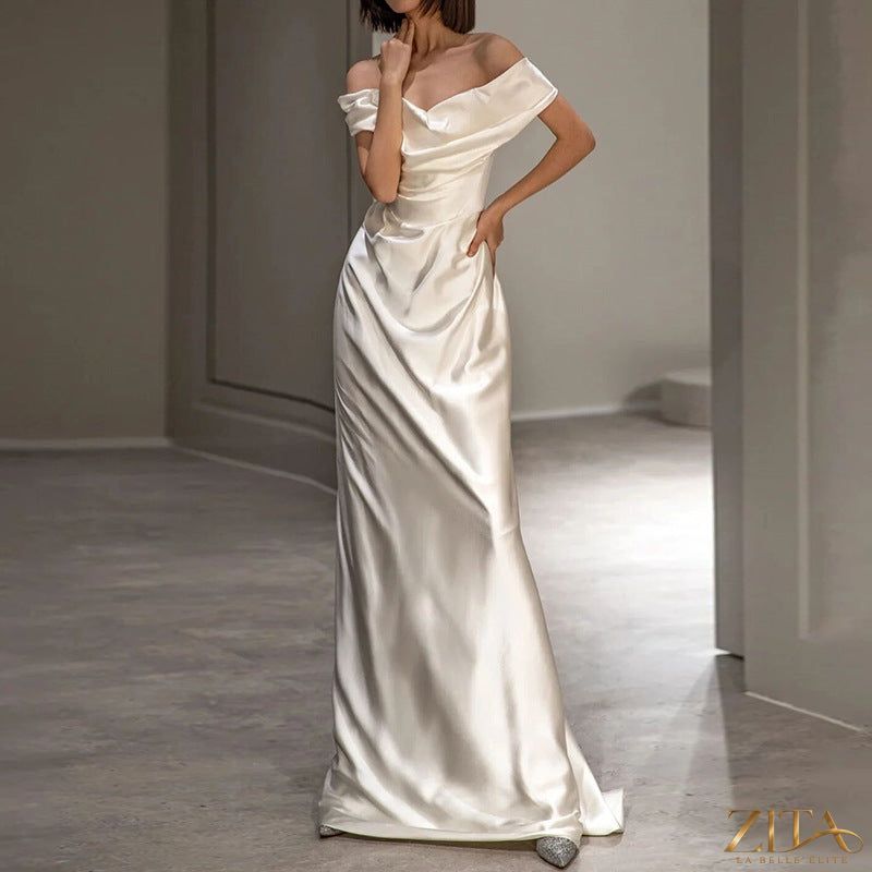Elegant white off-shoulder wedding dress by Zita La Belle Elite, featuring a light, flowing design for women.