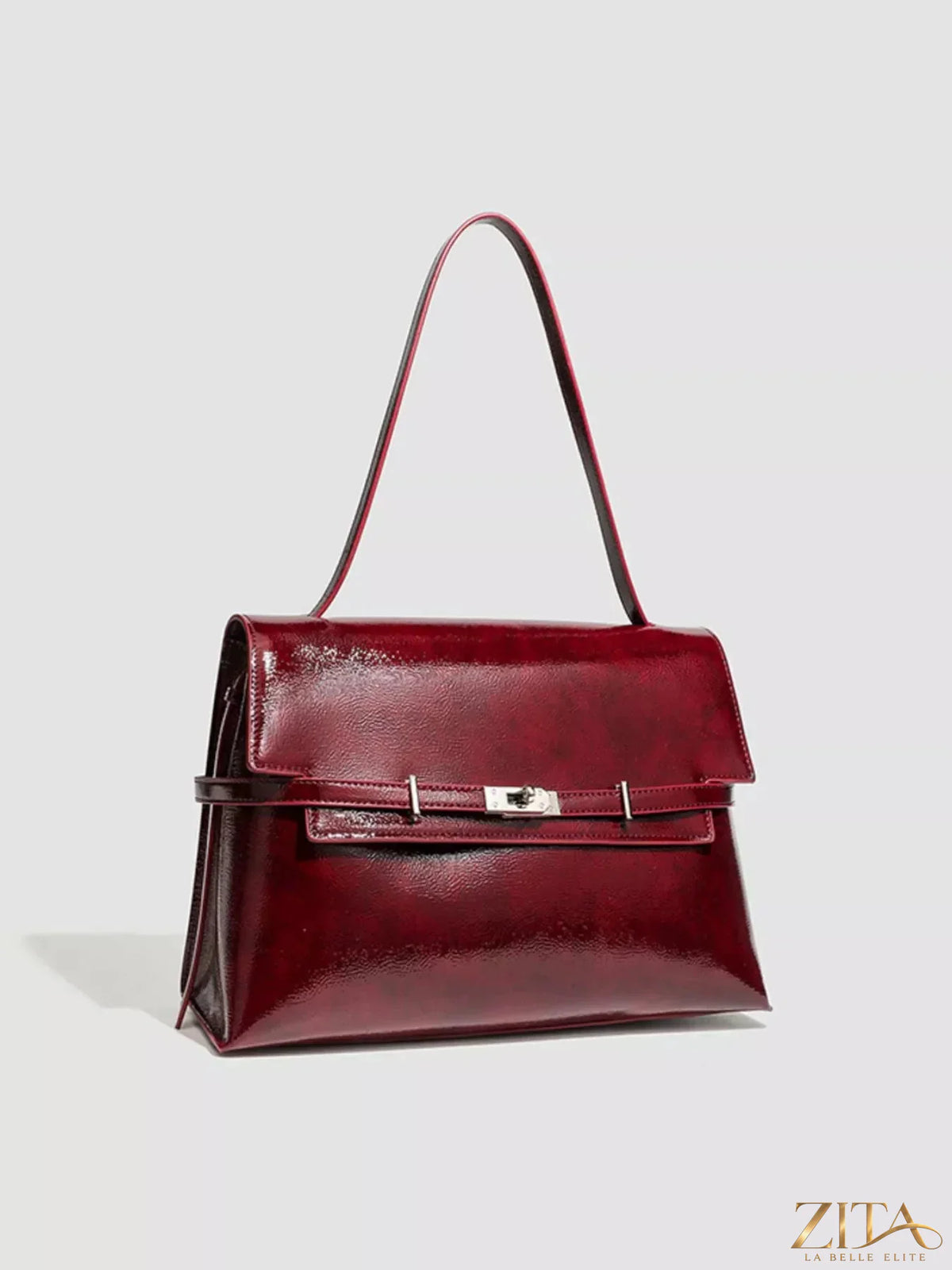 Zita La Belle Elite buckle leather shoulder bag with adjustable strap and front buckle detail on smooth brown leather surface