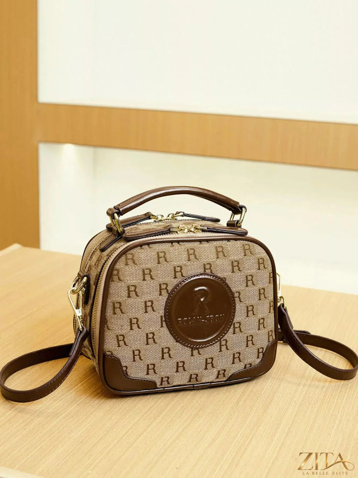 Zita La Belle Elite monogram pattern crossbody handbag with top handle, featuring a stylish design and gold-tone hardware.