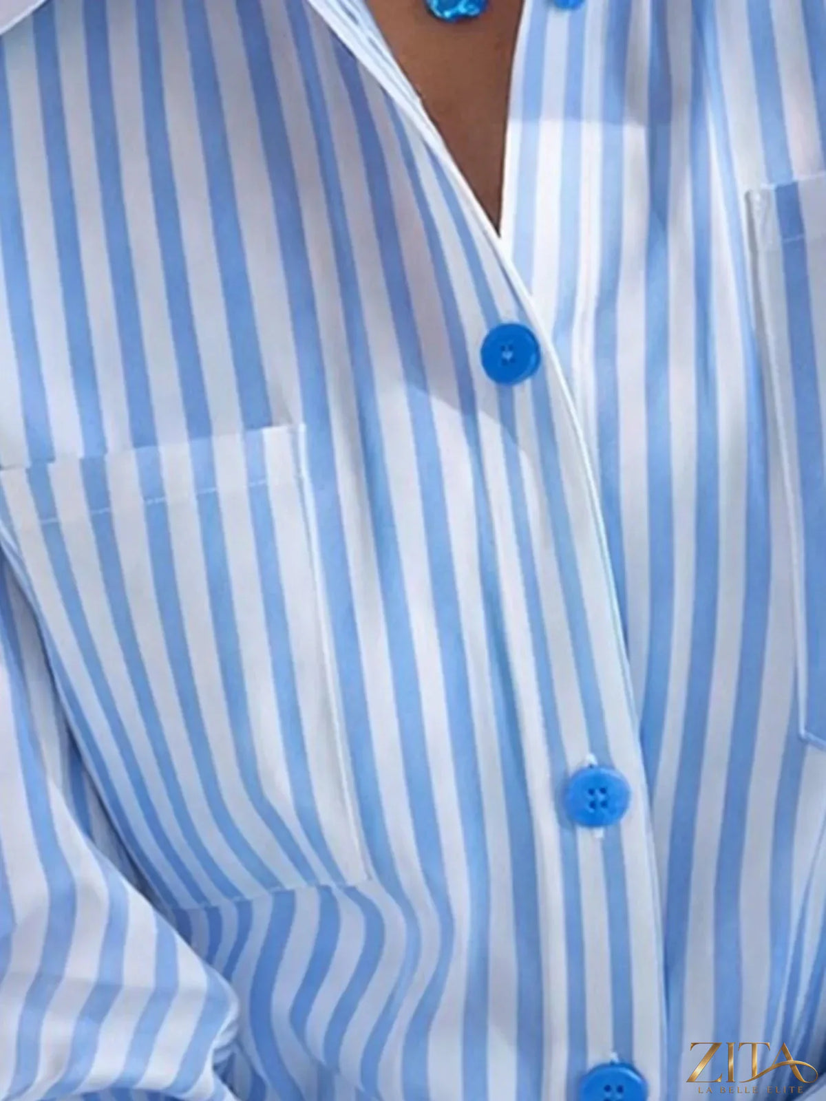 Zita La Belle Elite striped button-down shirt with blue and white vertical stripes, displayed on a hanger.