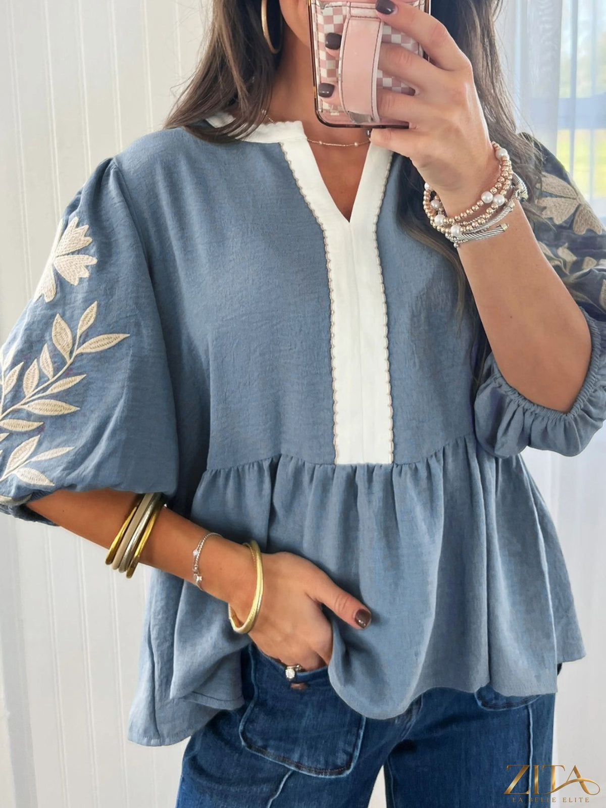 Zita La Belle Elite embroidered sleeve peplum blouse with detailed floral embroidery and ruffled cuffs on white fabric.
