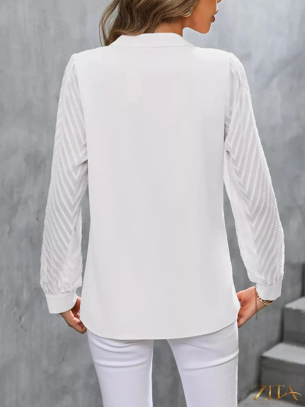 Zita La Belle Elite sheer sleeve V-neck blouse with lightweight fabric and elegant design, shown on a model.