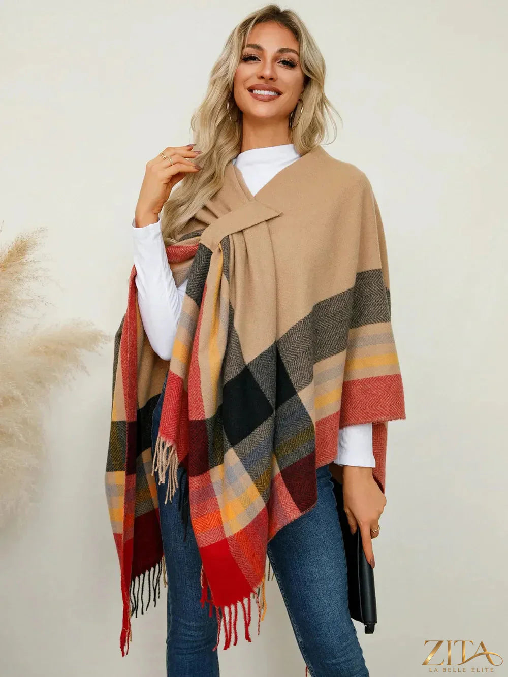 Trendsi fringe contrast plaid poncho with fringe trim and bold plaid pattern, worn as a stylish outer layer.