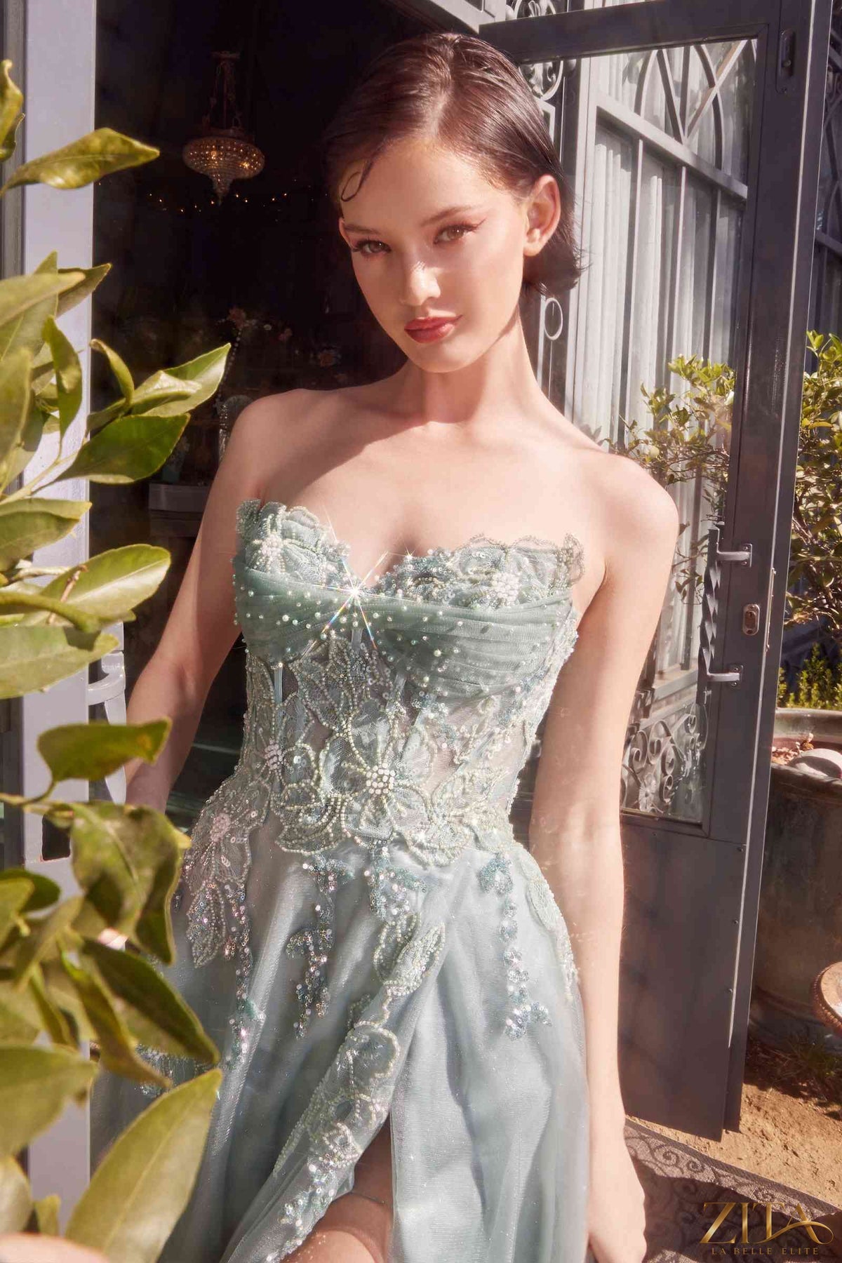 Elegant strapless layered tulle ball gown by Zita La Belle Elite, featuring a flowing skirt and intricate bodice details.