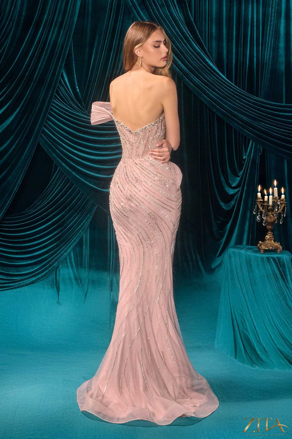 Back view of a mauve fitted evening gown by Zita La Belle Elite, showcasing elegant details and luxurious fabric.
