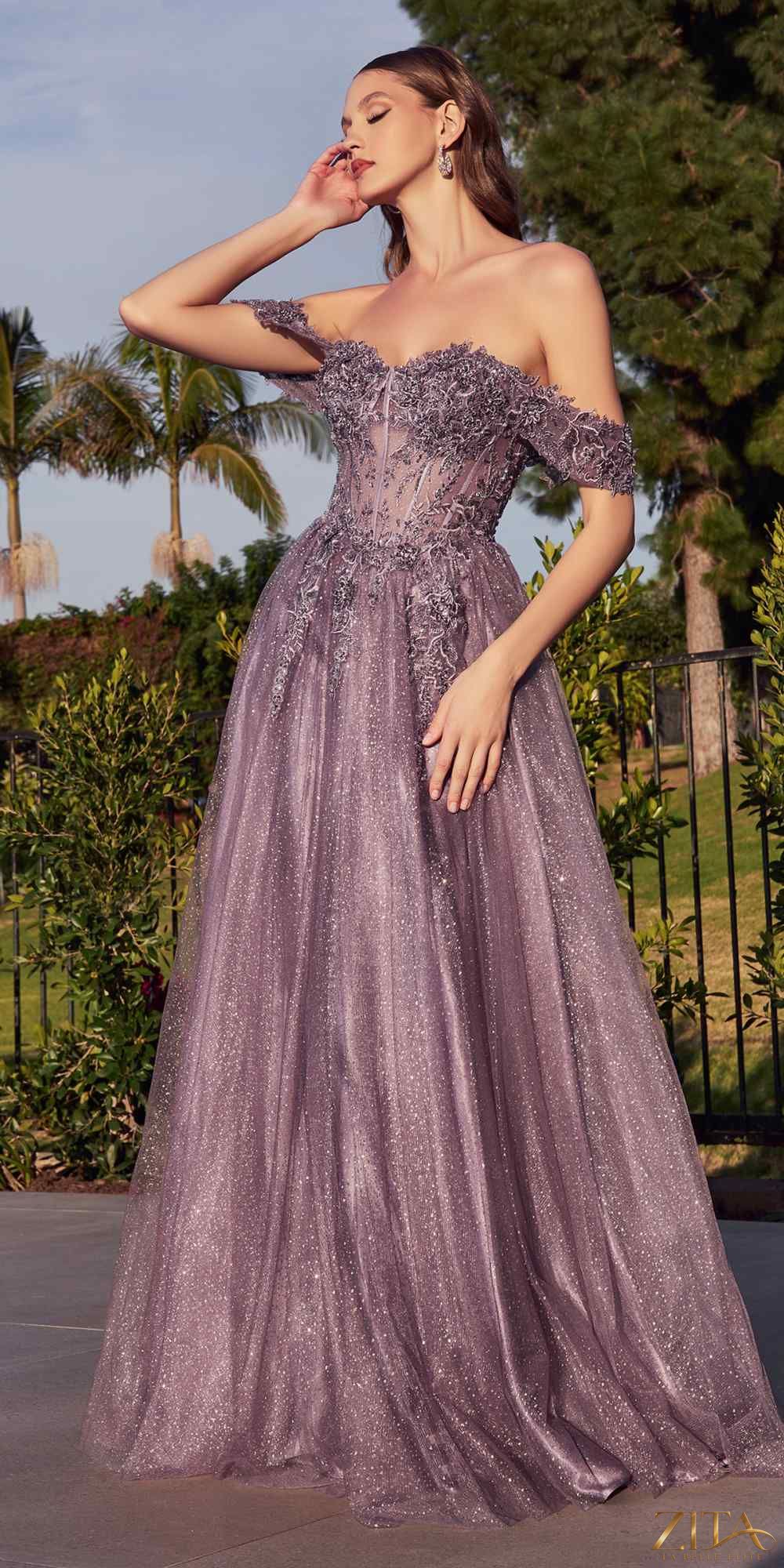 Elegant violet off-shoulder lace A-line gown by Zita La Belle Elite, featuring intricate lace details and a flowing silhouette.
