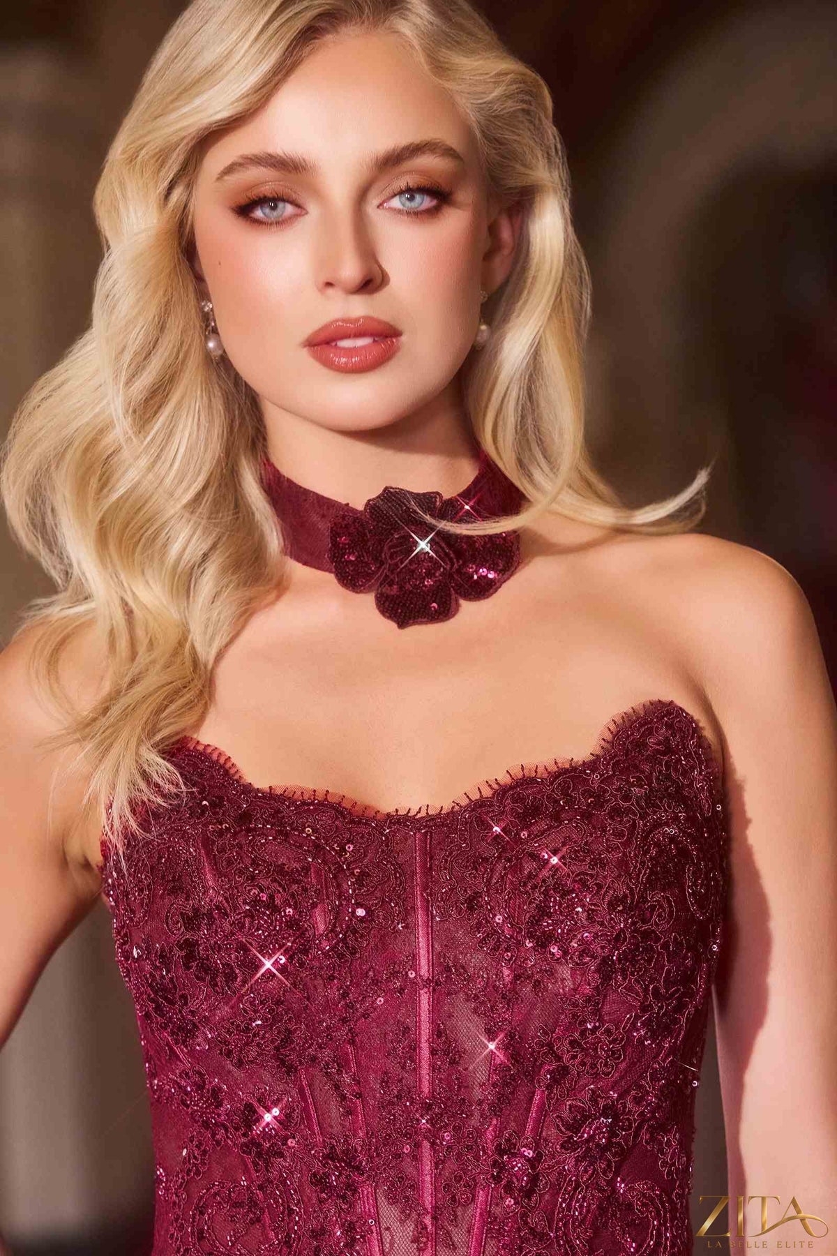 Elegant burgundy strapless fit and flare evening gown with matching choker from Zita La Belle Elite.