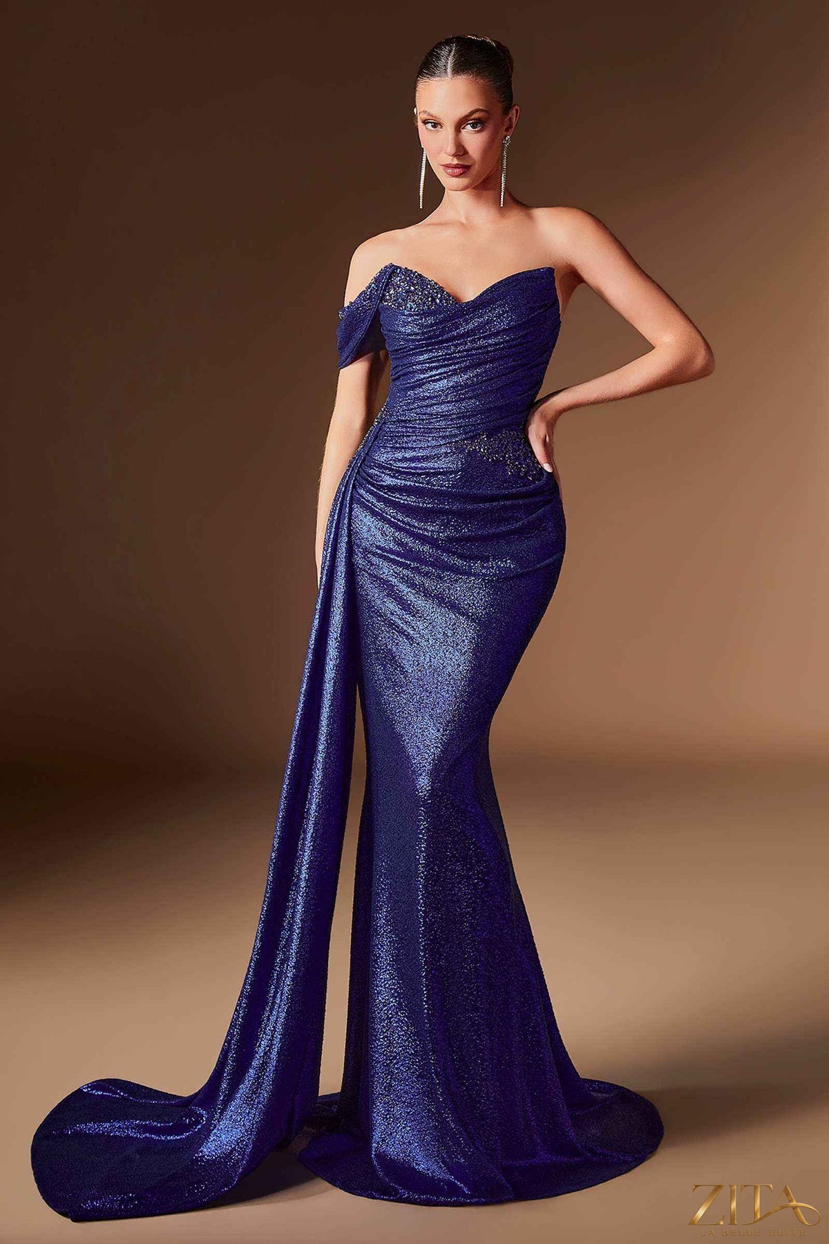 Royal blue one-shoulder metallic fitted dress with sash by Zita La Belle Elite, showcasing elegant design and shiny fabric.