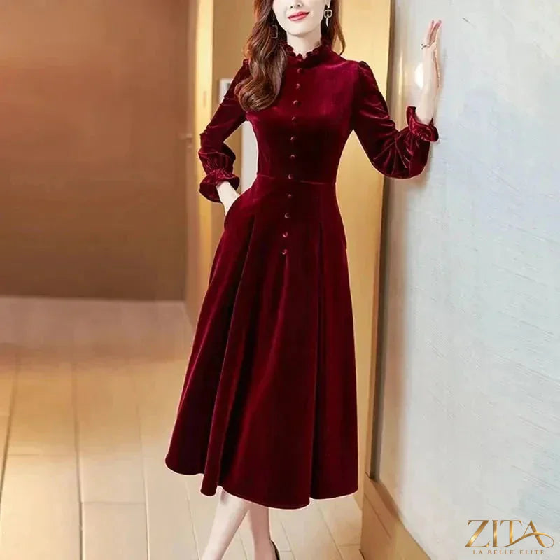Women’s wine red velvet maxi dress with long sleeves by Zita La Belle Elite, featuring a flowing elegant design.