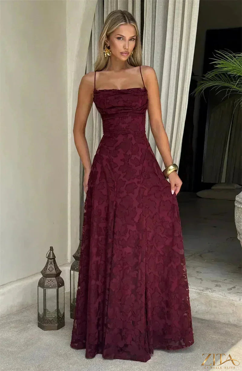 Backless woman’s spaghetti strap lace-up maxi evening dress by Zita La Belle Elite, flowing fabric and elegant design.