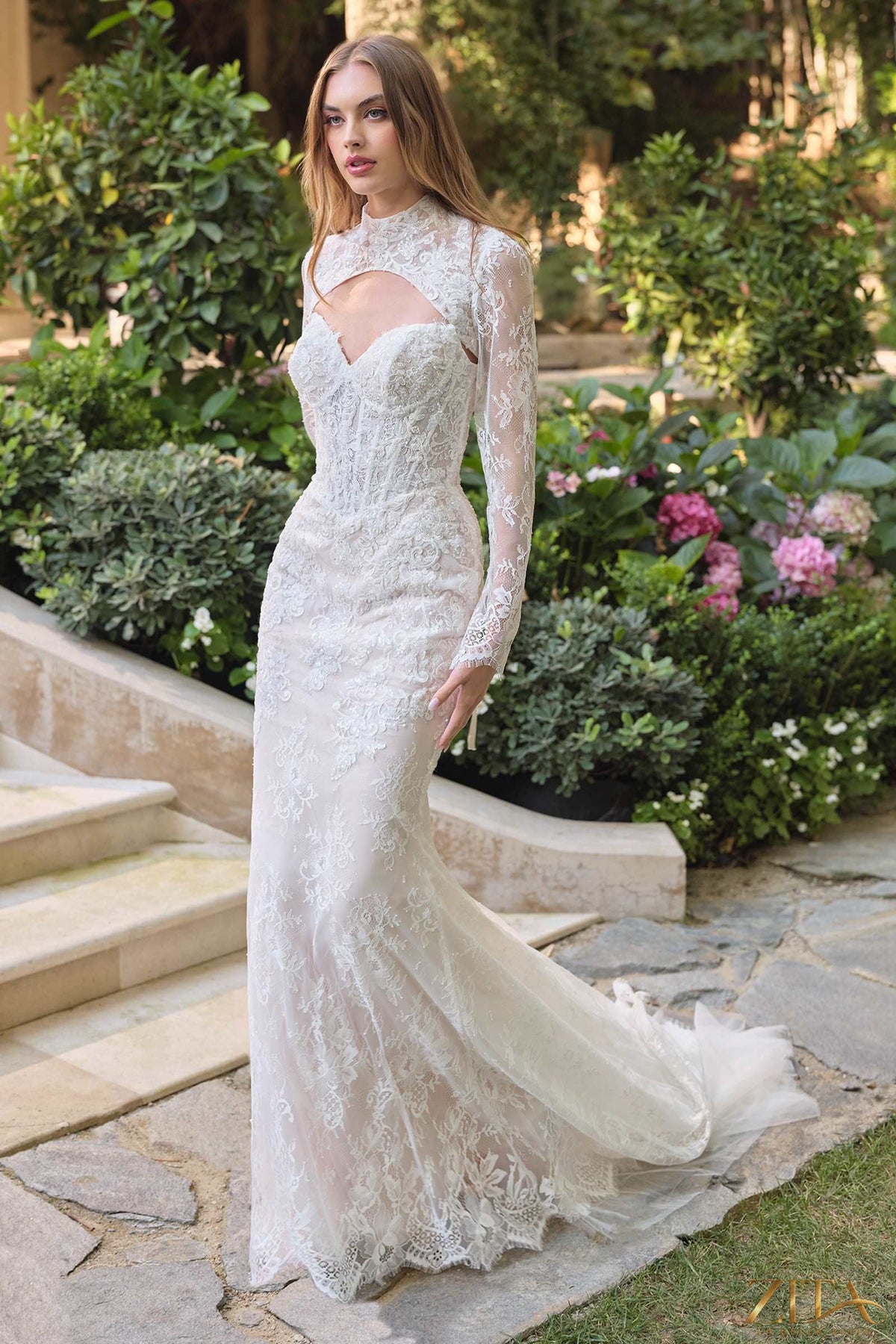 Elegant white fit and flare wedding dress with lace overlay and matching bolero jacket by Zita La Belle Elite.