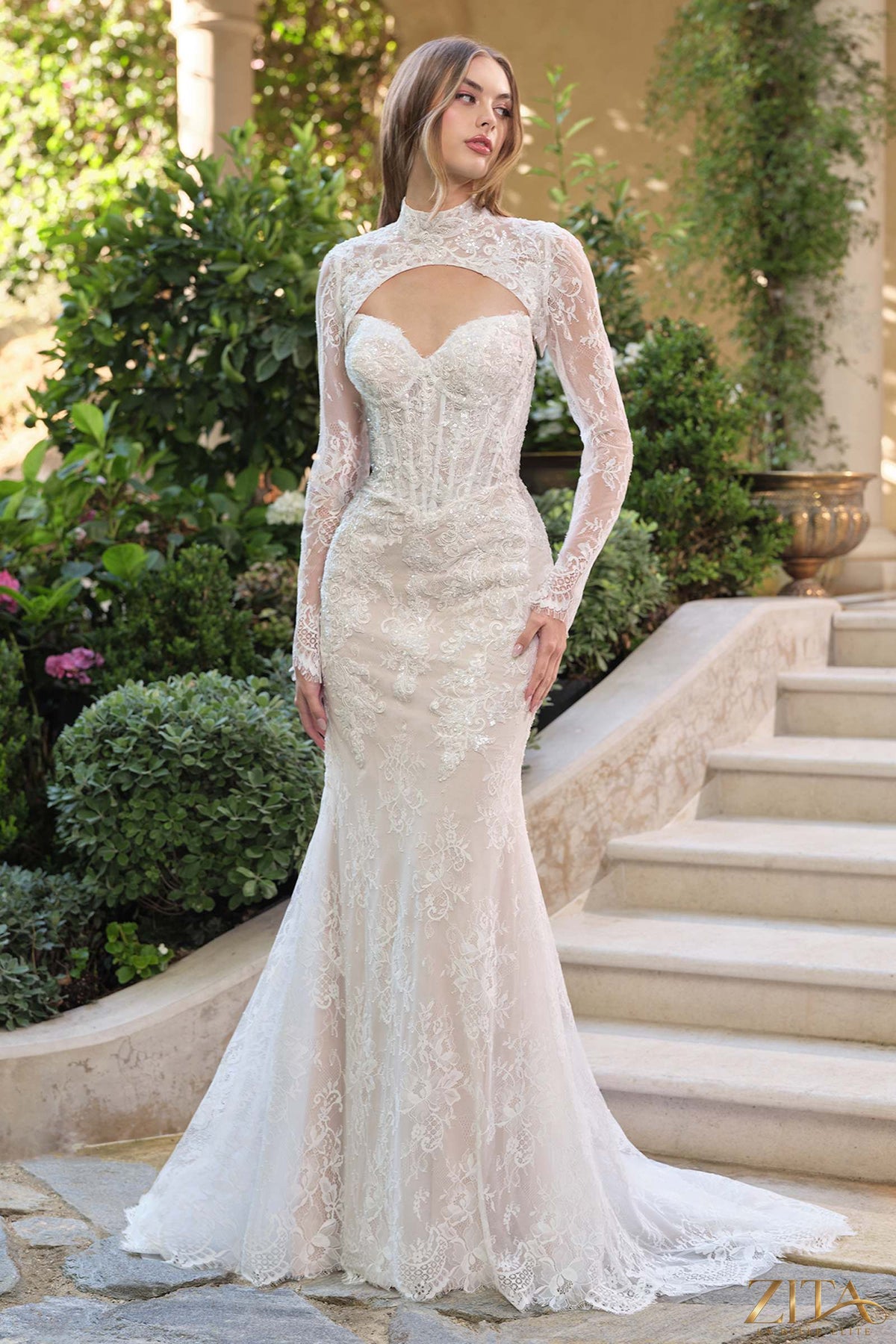 Off-white fit and flare lace overlay wedding dress with matching bolero jacket by Zita La Belle Elite, front view.