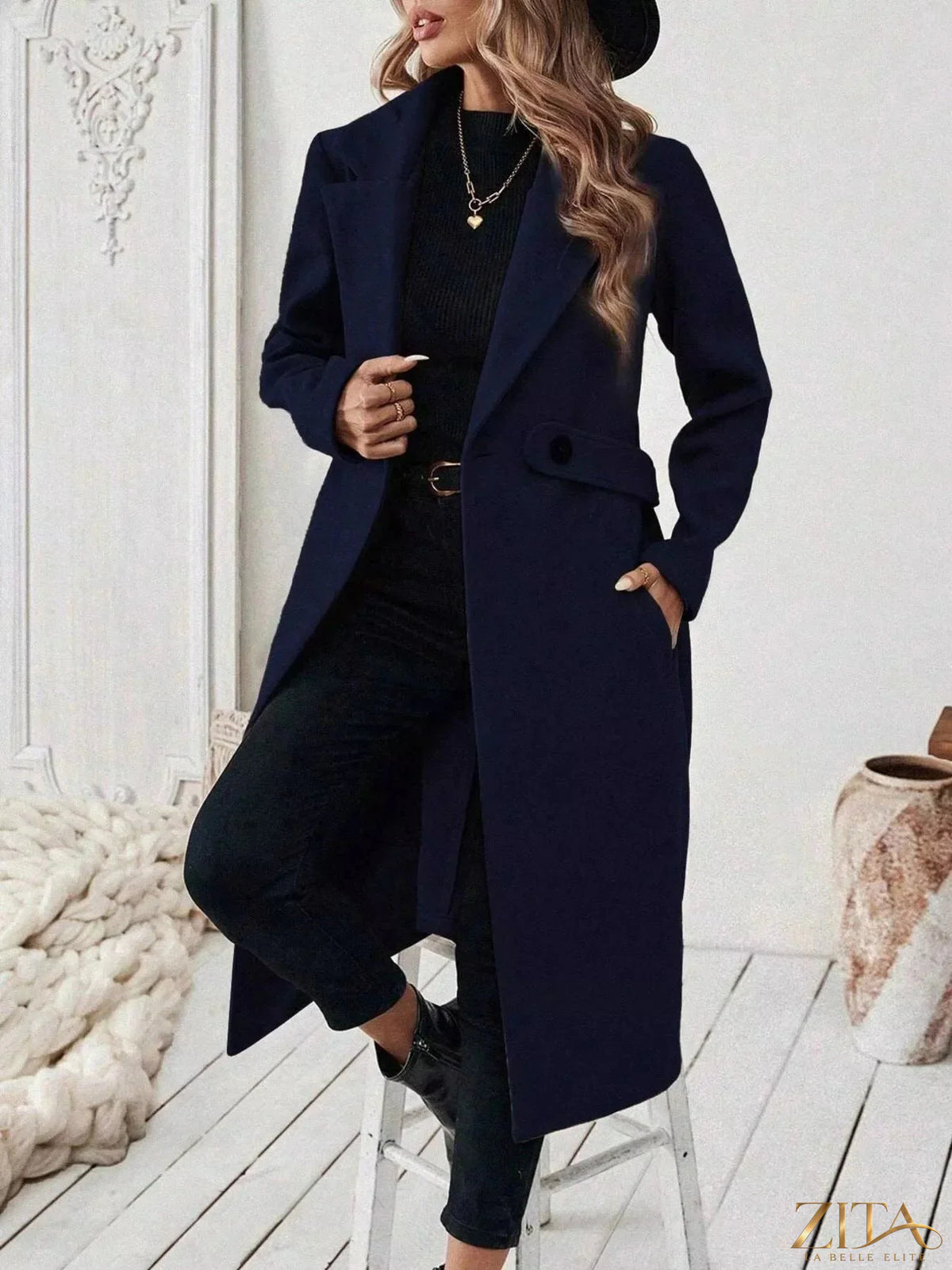 Zita La Belle Elite single-button longline coat in neutral fabric, displayed hanging on a wooden hanger.