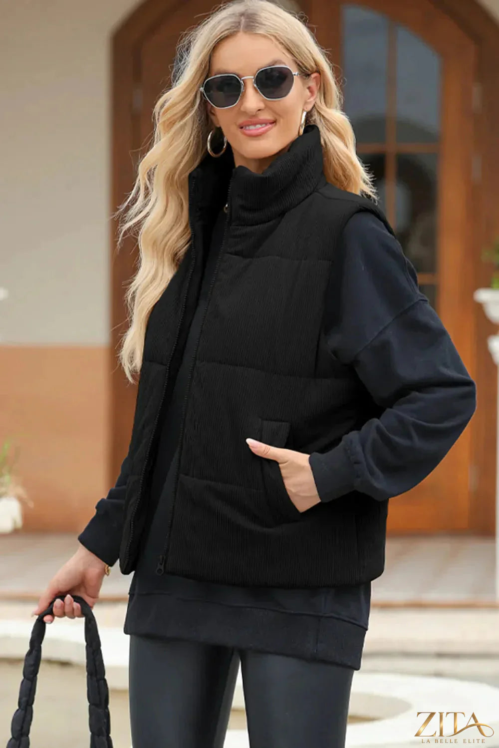 Trendsi pocketed zip-up turtleneck vest coat in black, featuring a high collar, front pockets, and a snug fit.