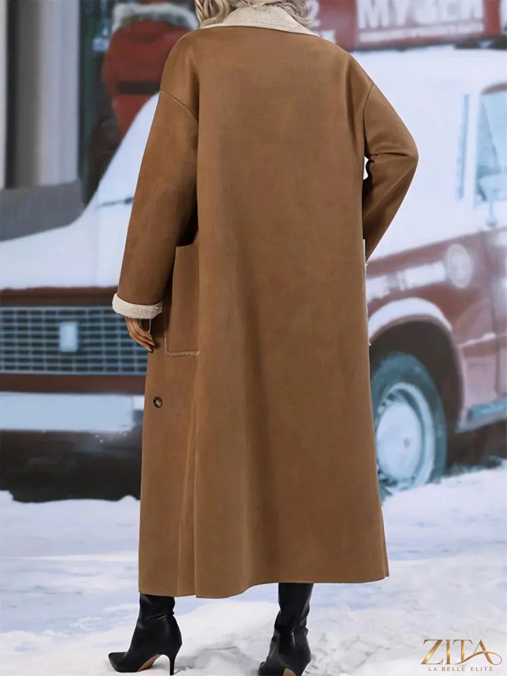 Plus size Zita La Belle Elite drop shoulder sherpa longline coat hanging on a clothing rack, showcasing its cozy, oversized design.
