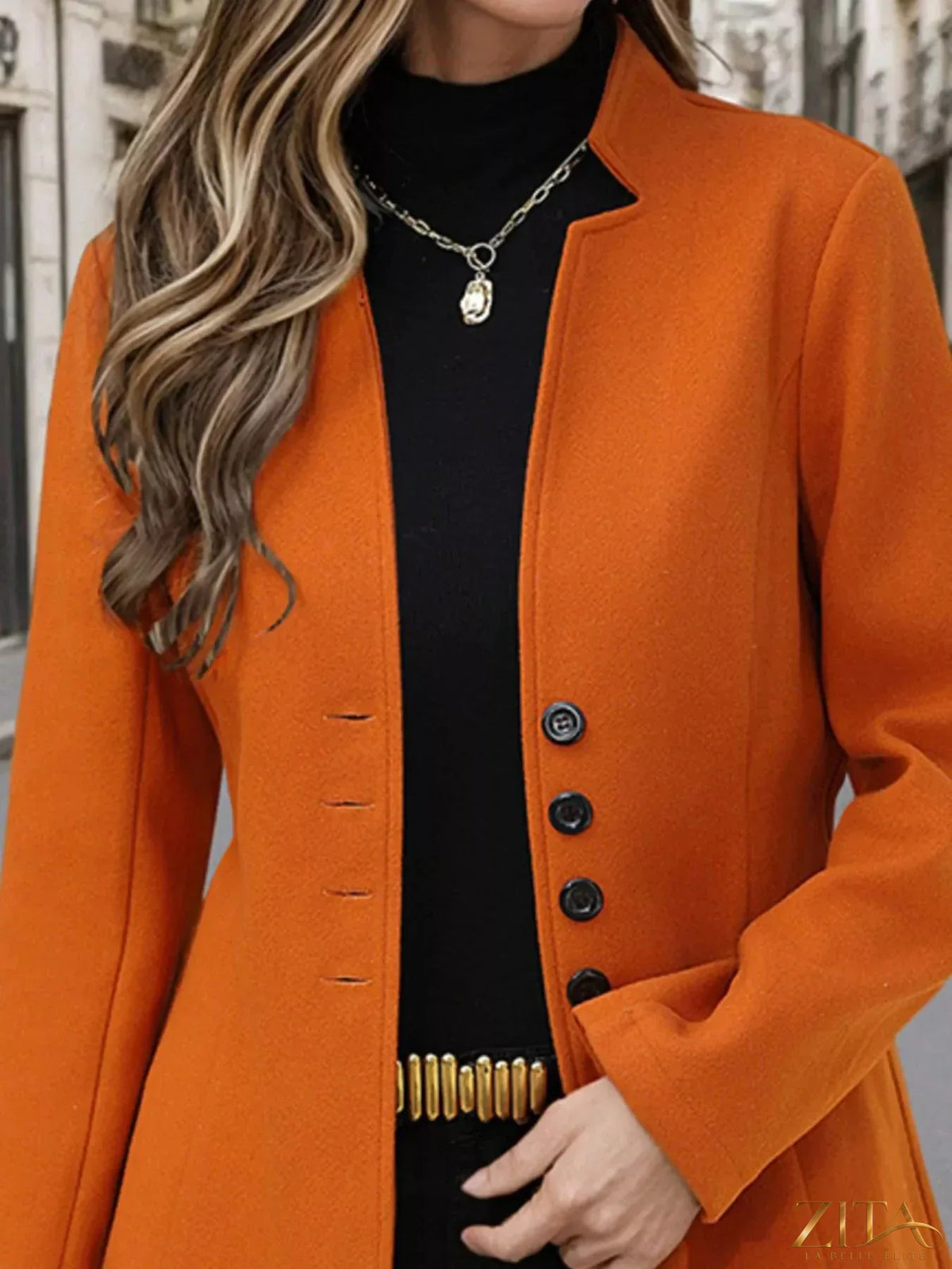 Zita La Belle Elite button-up long sleeve coat hanging on a wooden door, featuring a classic design and tailored fit.