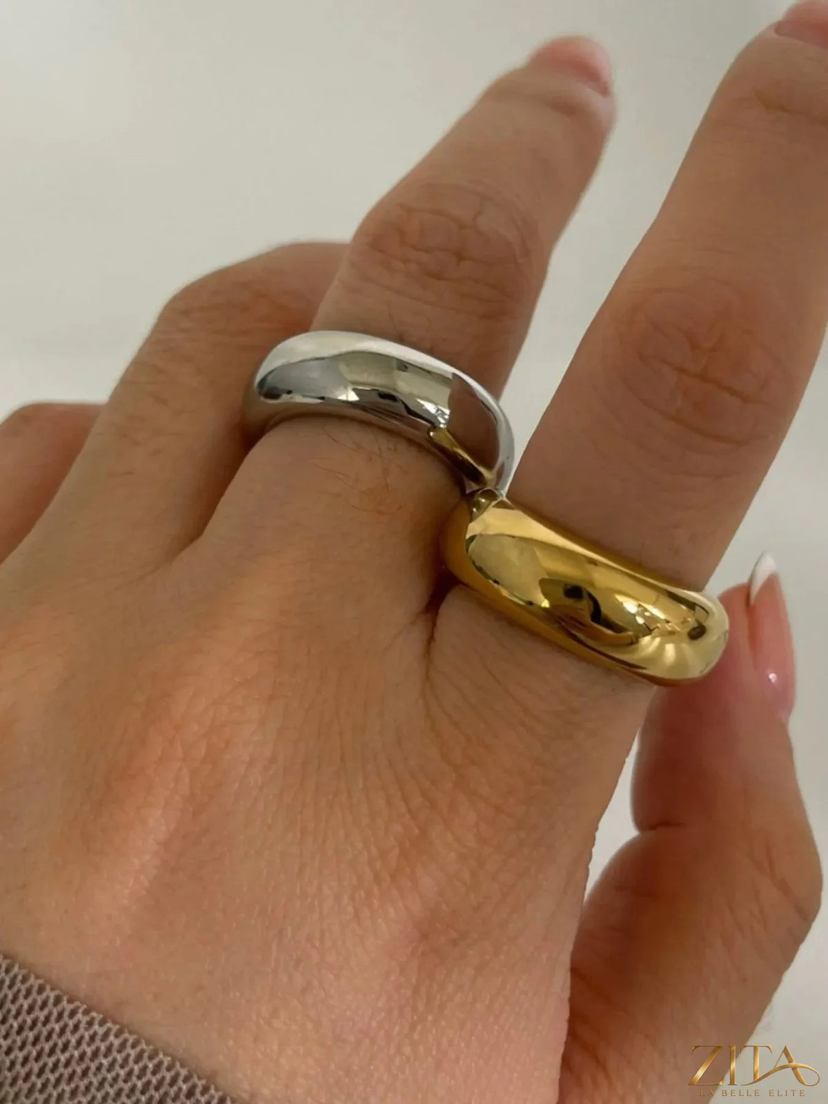Two 18K gold-plated stainless steel dome band rings from Zita La Belle Elite, showcasing smooth, polished finish on a white background.
