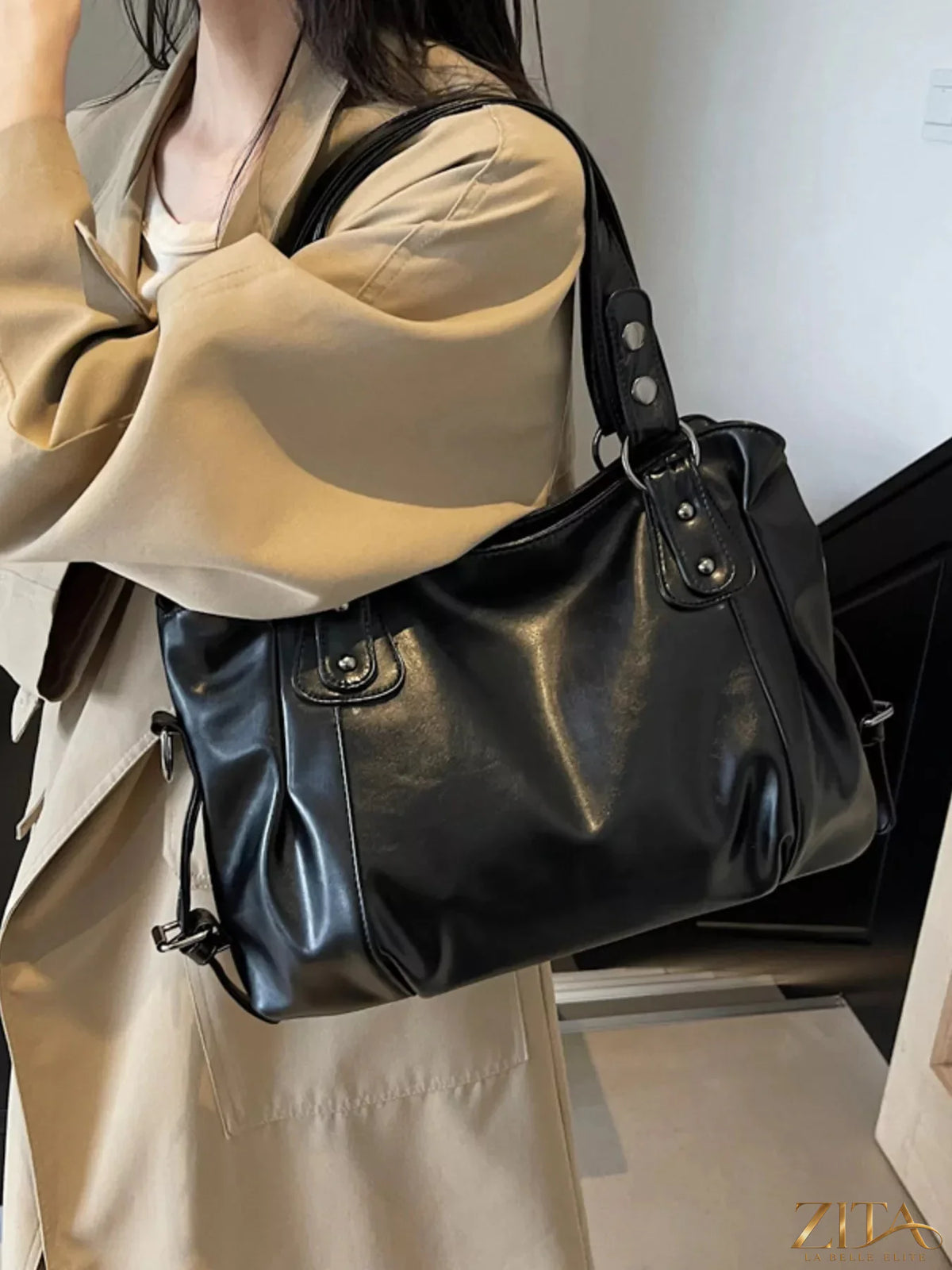 Vintage style leather handbag by Trendsi featuring a classic design, brown leather with sturdy handles and subtle stitching details.