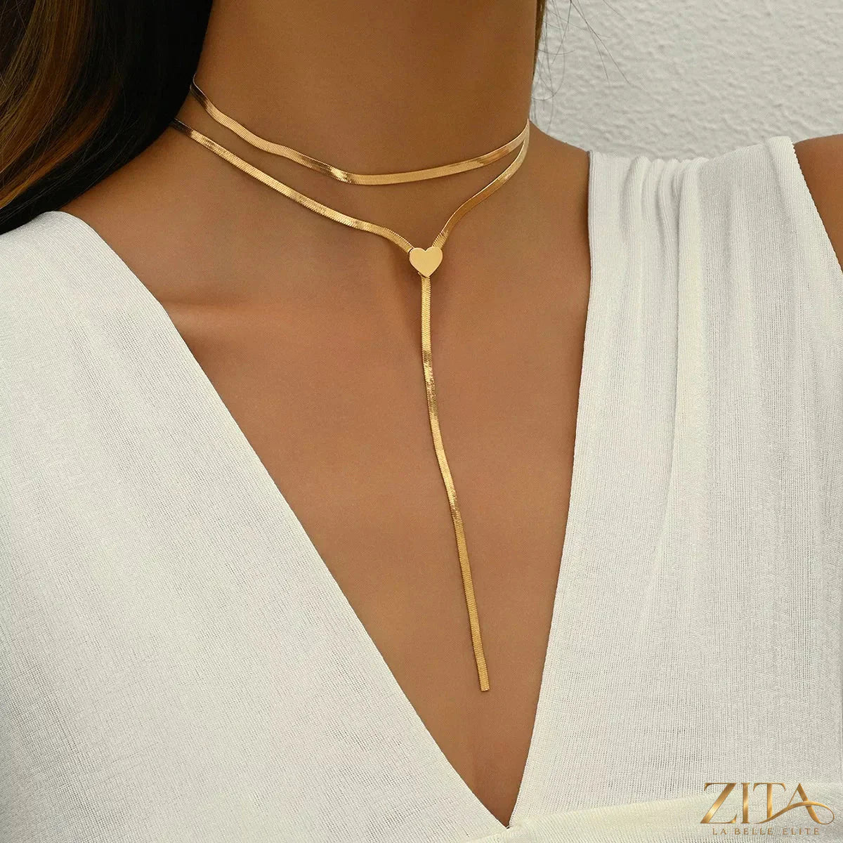 Two 18K gold-plated heart necklaces from Zita La Belle Elite, featuring delicate chain and charming heart pendants.