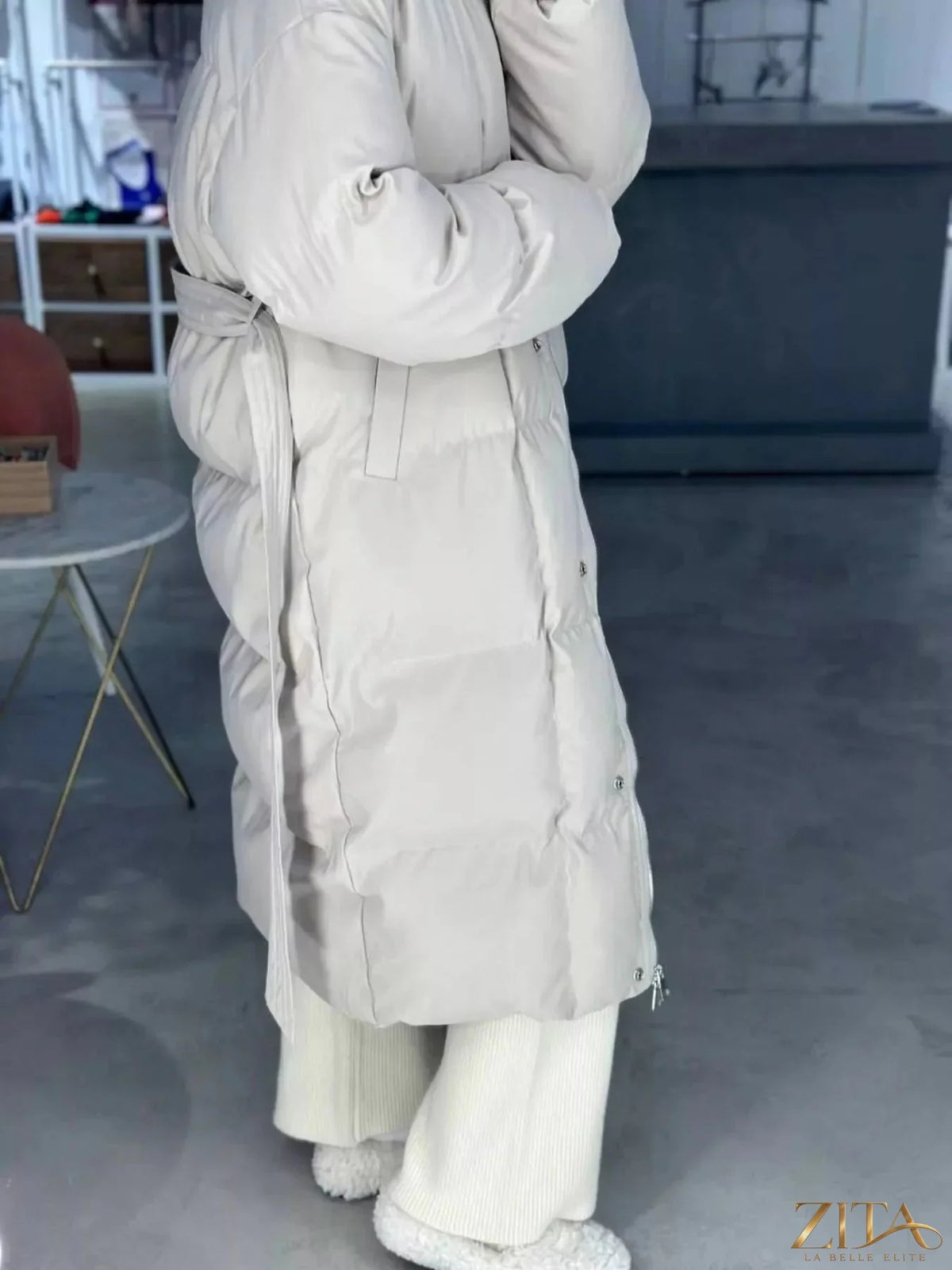 Longline padded winter coat with belt from Zita La Belle Elite, showcasing a stylish, insulated design for cold weather.