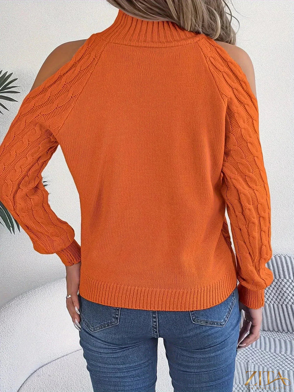 Cold-shoulder cable knit sweater from Trendsi featuring a cozy, textured design with open shoulder details and ribbed cuffs.
