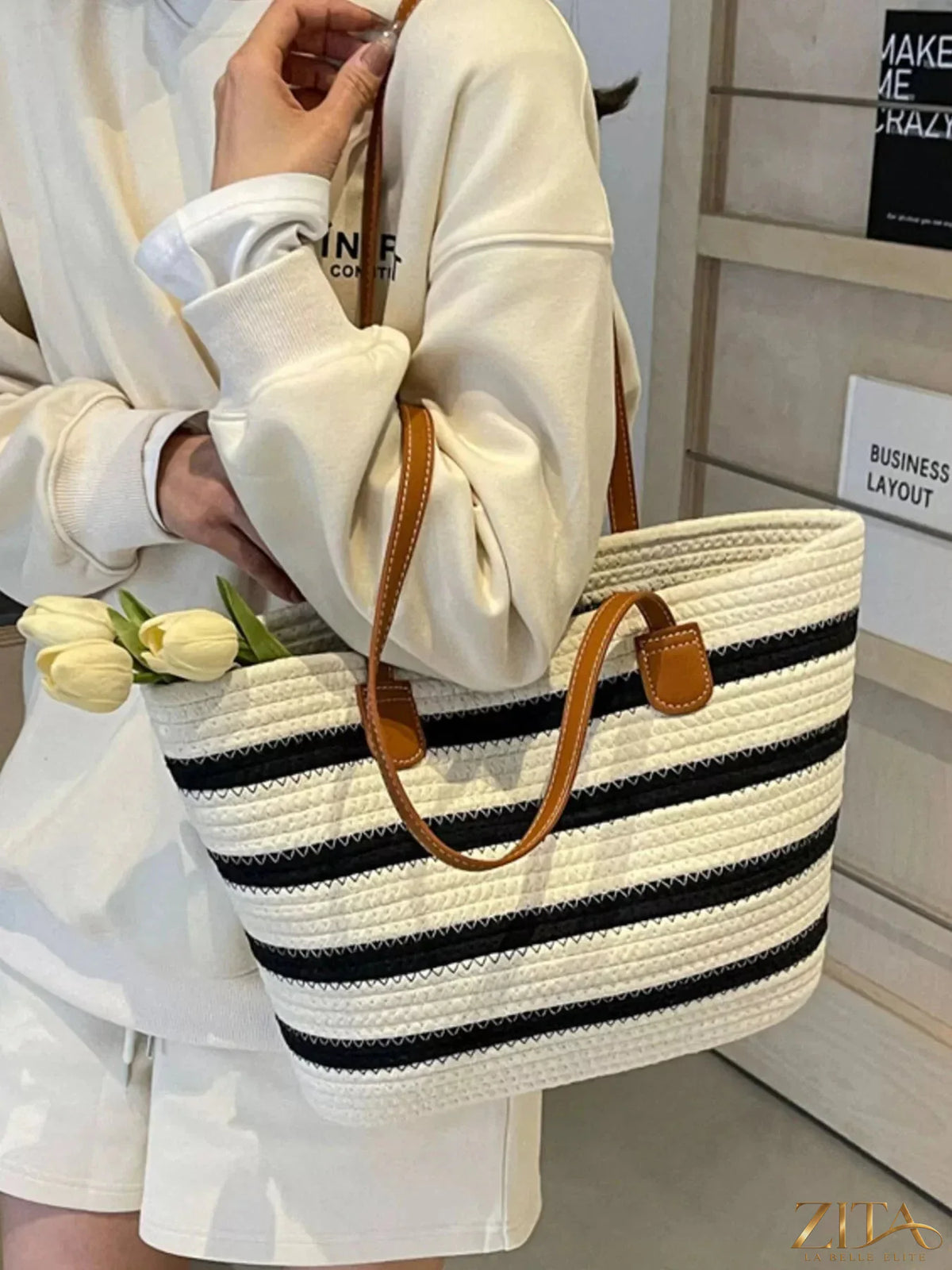 Striped straw tote bag by Zita La Belle Elite, showing woven texture and colorful striped pattern with sturdy handles.