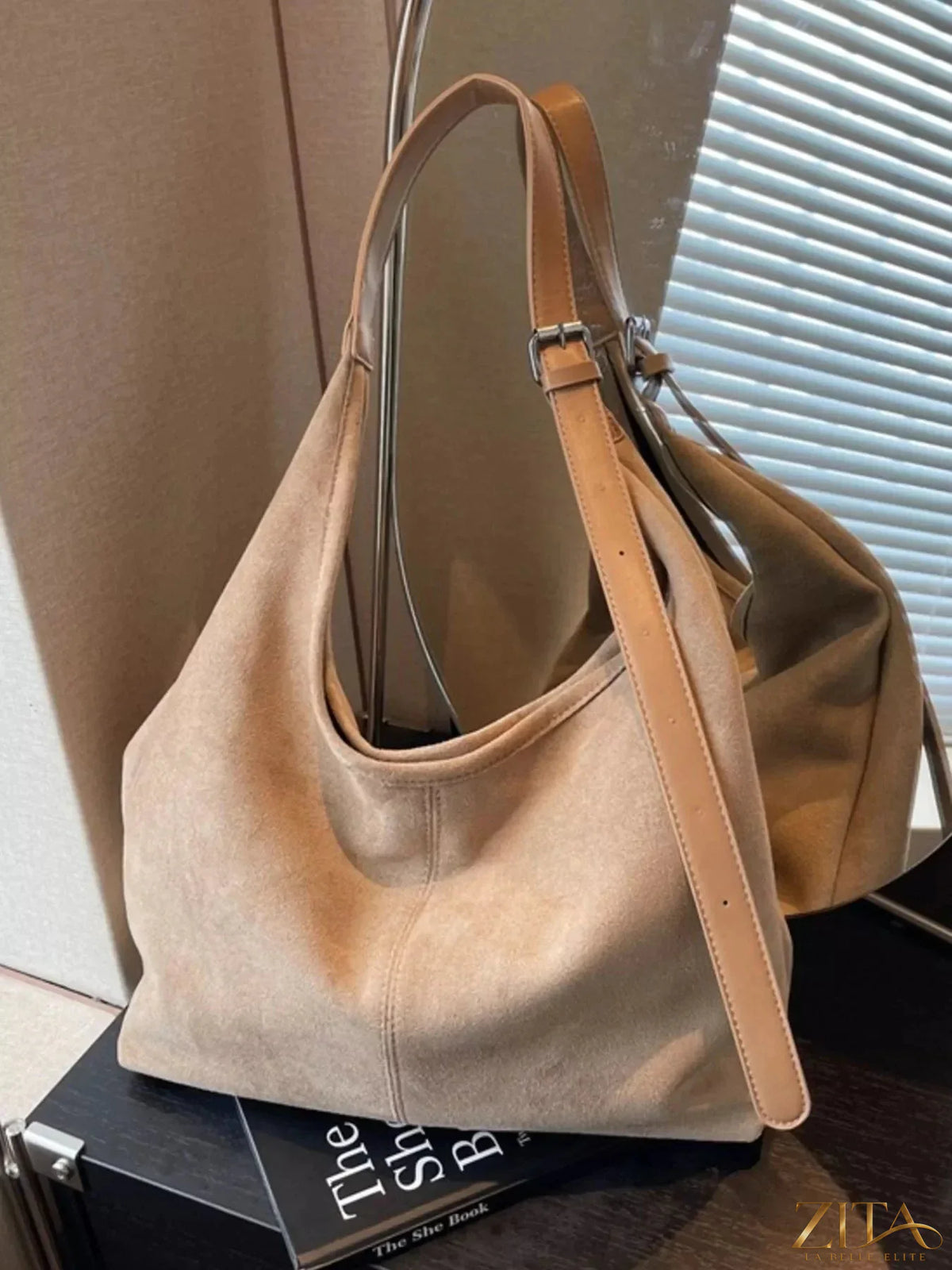 Lightweight Zita La Belle Elite adjustable strap handbag with a sleek design and neutral color, featuring a spacious interior.