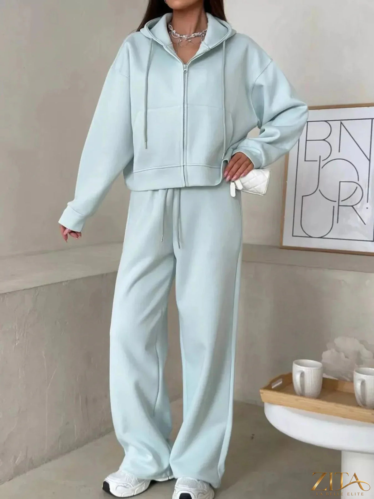 Zita La Belle Elite zip-up hoodie and wide-leg pants set in soft fabric, shown in a stylish, casual outdoor setting.