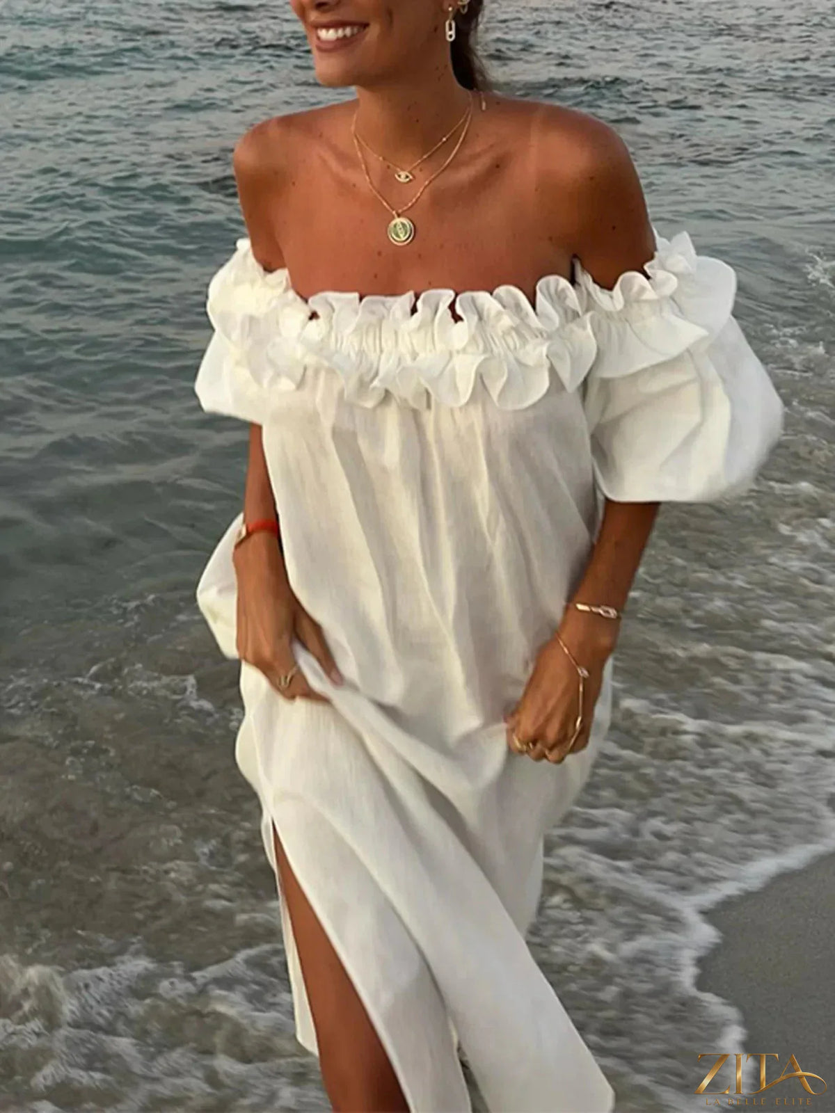 Zita La Belle Elite side slit off-shoulder dress featuring a flowy fabric and stylish design, perfect for elegant occasions.