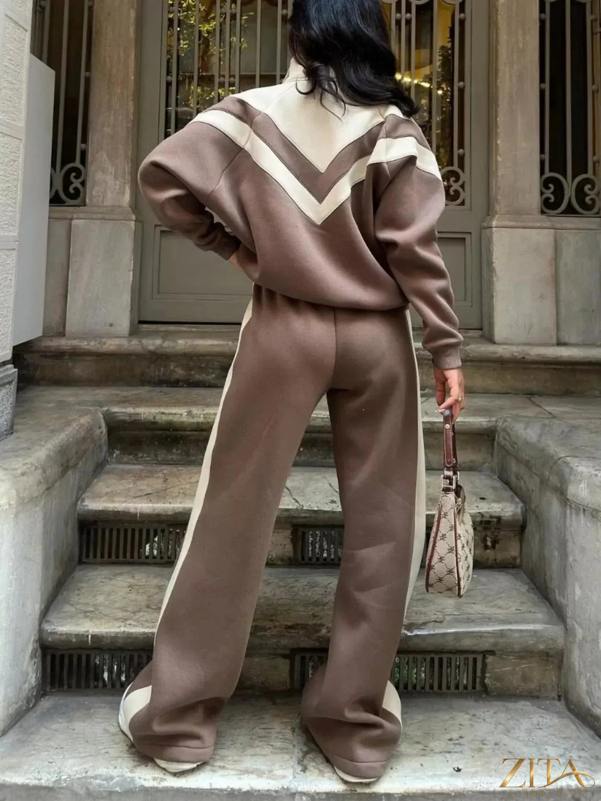 Color block zip-up outerwear and pants set by Zita La Belle Elite, featuring vibrant, contrasting panels in a stylish casual look.