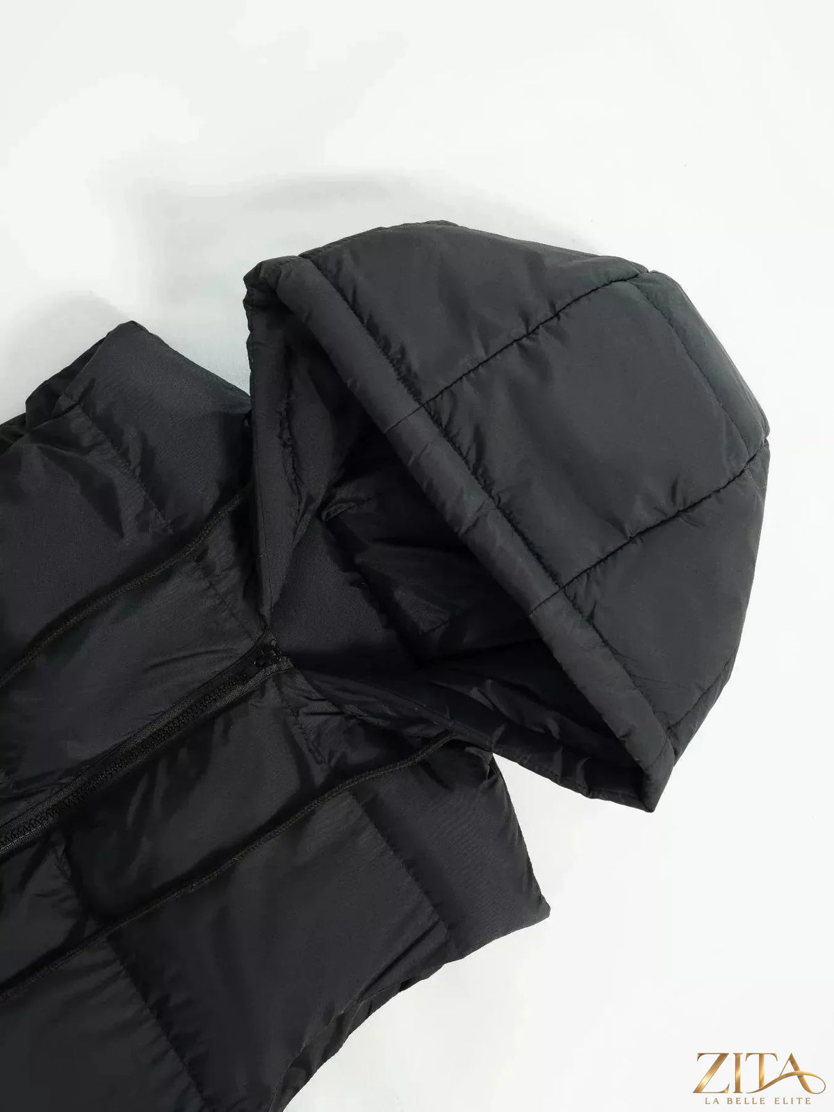 Longline padded hooded vest coat by Zita La Belle Elite, featuring a warm padded design and hood for winter warmth.