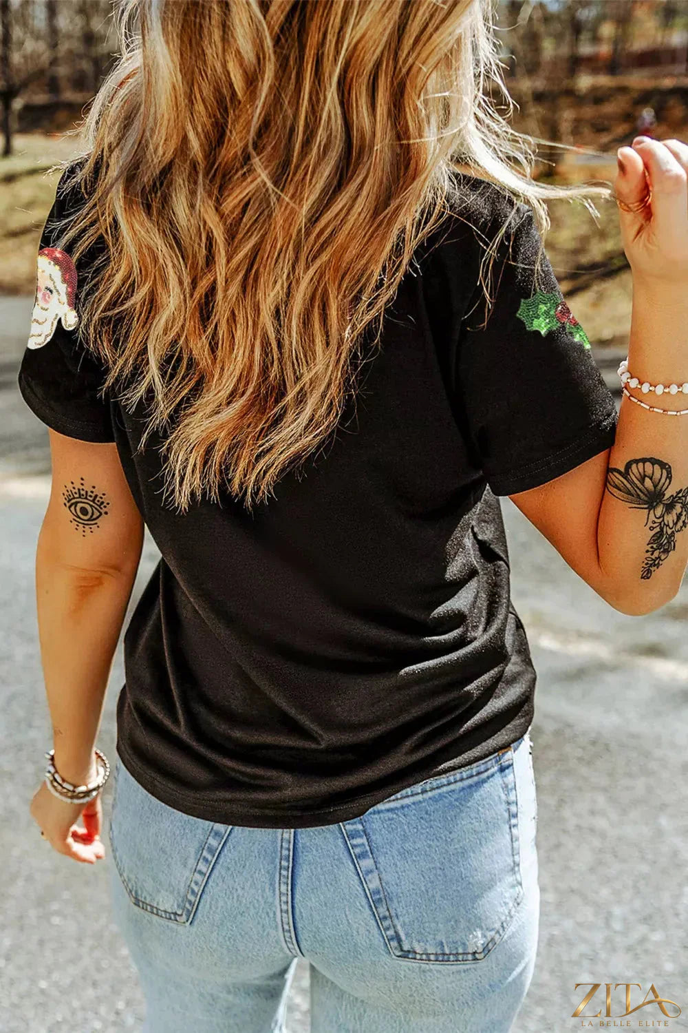 Christmas Holly Santa Claus graphic T-shirt with sequins and patches, trendy holiday shirt by Trendsi featuring festive design.