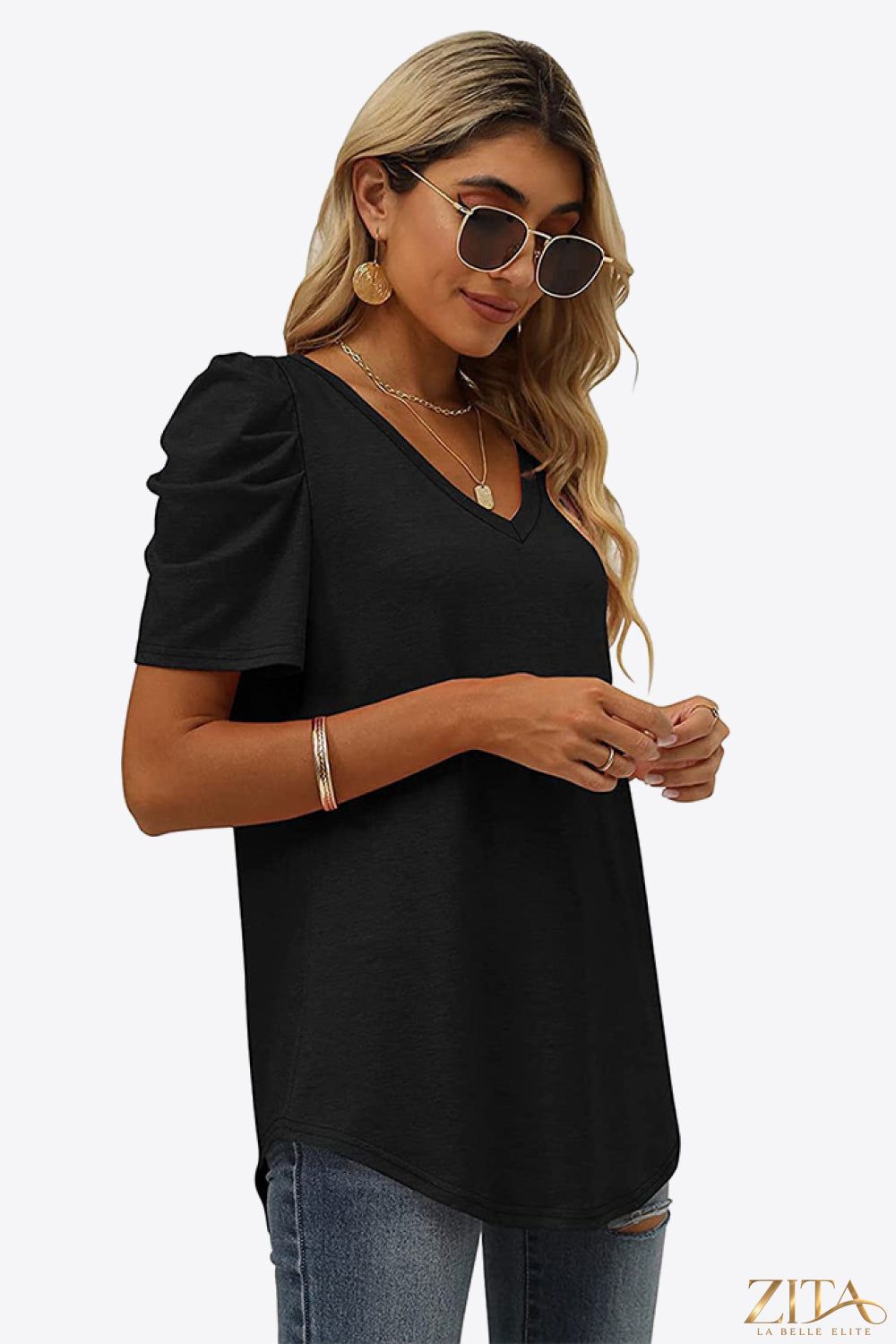 V-Neck Puff Sleeve Tee by Trendsi featuring a fitted V-neck design and stylish puff sleeves, shown in a soft, neutral fabric.